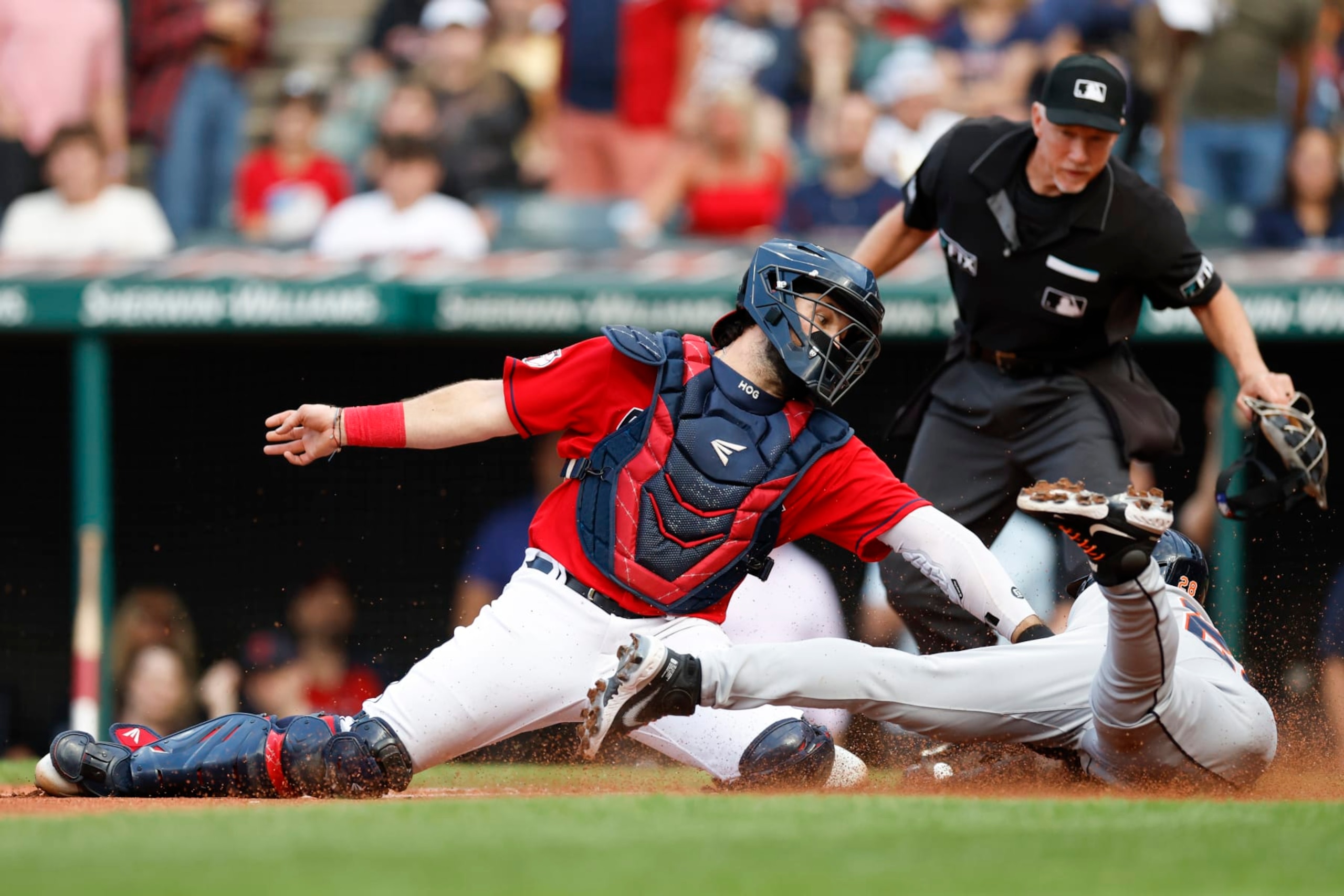 Detroit Tigers' Javier Baez scores past Cleveland Guardians catcher Austin Hedges on a ball hit by Harold Castro, while home plate umpire Lance Barksdale watches during the first inning of a baseball game Tuesday, Aug. 16, 2022, in Cleveland. (AP Photo/Ron Schwane) Detroit Tigers' Javier Baez scores past Cleveland Guardians catcher Austin Hedges on a ball hit by Harold Castro, while home plate umpire Lance Barksdale watches during the first inning of a baseball game Tuesday, Aug. 16, 2022, in Cleveland. (AP Photo/Ron Schwane)