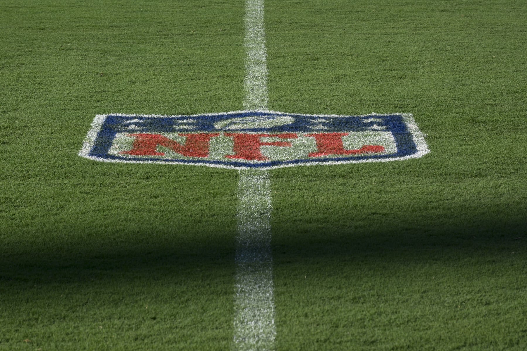 The NFL logo is seen on the field at M&T Bank Stadium prior to an NFL football game between the Baltimore Ravens and the Tennessee Titans, Thursday, Aug. 11, 2022, in Baltimore. (AP Photo/Nick Wass)