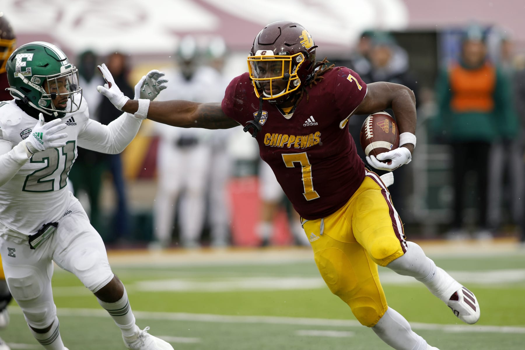 Central Michigan's Lew Nichols III, right, rushes against Eastern Michigan's Robert Daniel Jr. (21) during an NCAA college football game, Friday, Nov. 26, 2021, in Mount Pleasant, Mich. Central Michigan won 31-10. (AP Photo/Al Goldis)