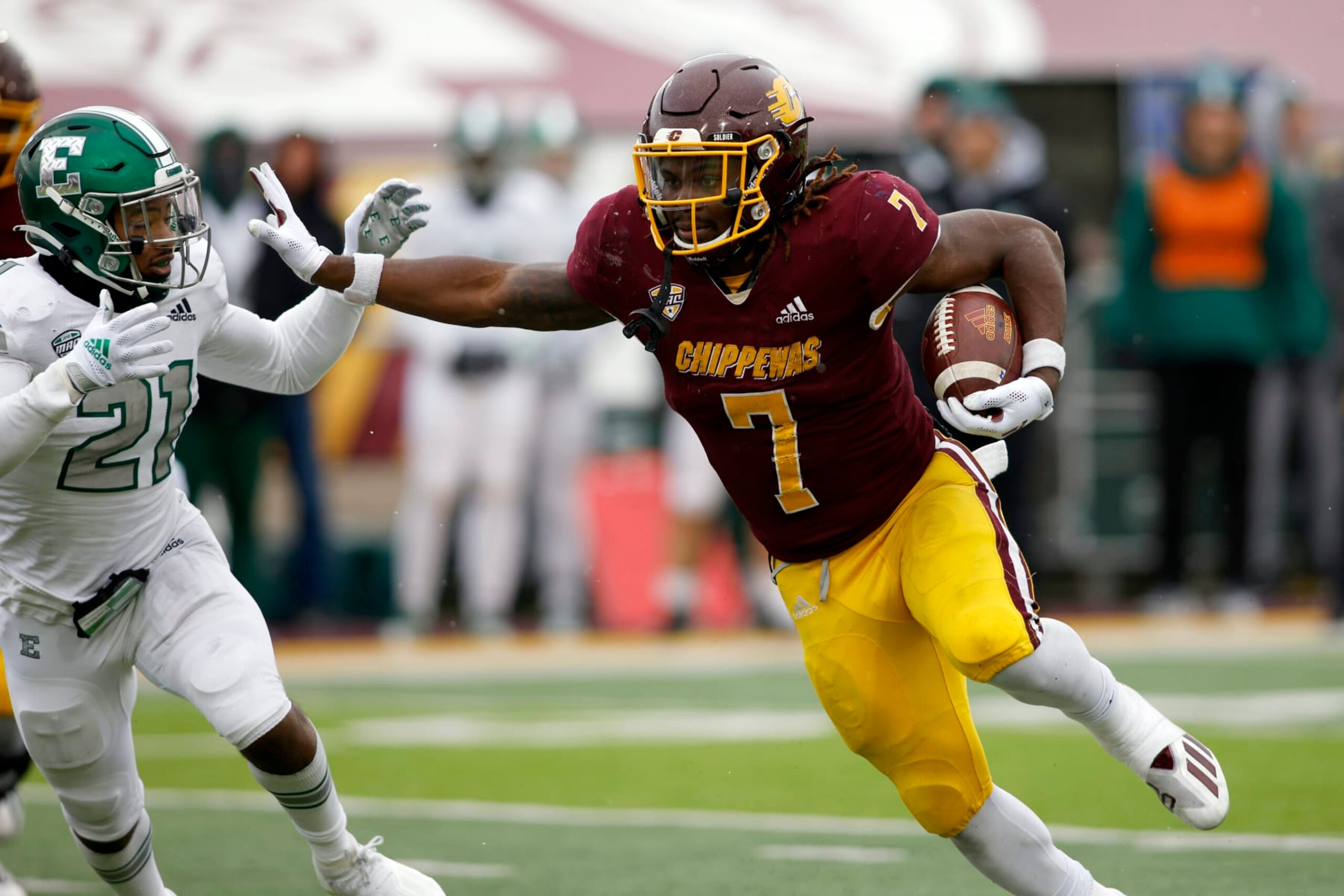 Central Michigan's Lew Nichols III, right, rushes against Eastern Michigan's Robert Daniel Jr. (21) during an NCAA college football game, Friday, Nov. 26, 2021, in Mount Pleasant, Mich. Central Michigan won 31-10. (AP Photo/Al Goldis) Central Michigan's Lew Nichols III, right, rushes against Eastern Michigan's Robert Daniel Jr. (21) during an NCAA college football game, Friday, Nov. 26, 2021, in Mount Pleasant, Mich. Central Michigan won 31-10. (AP Photo/Al Goldis)