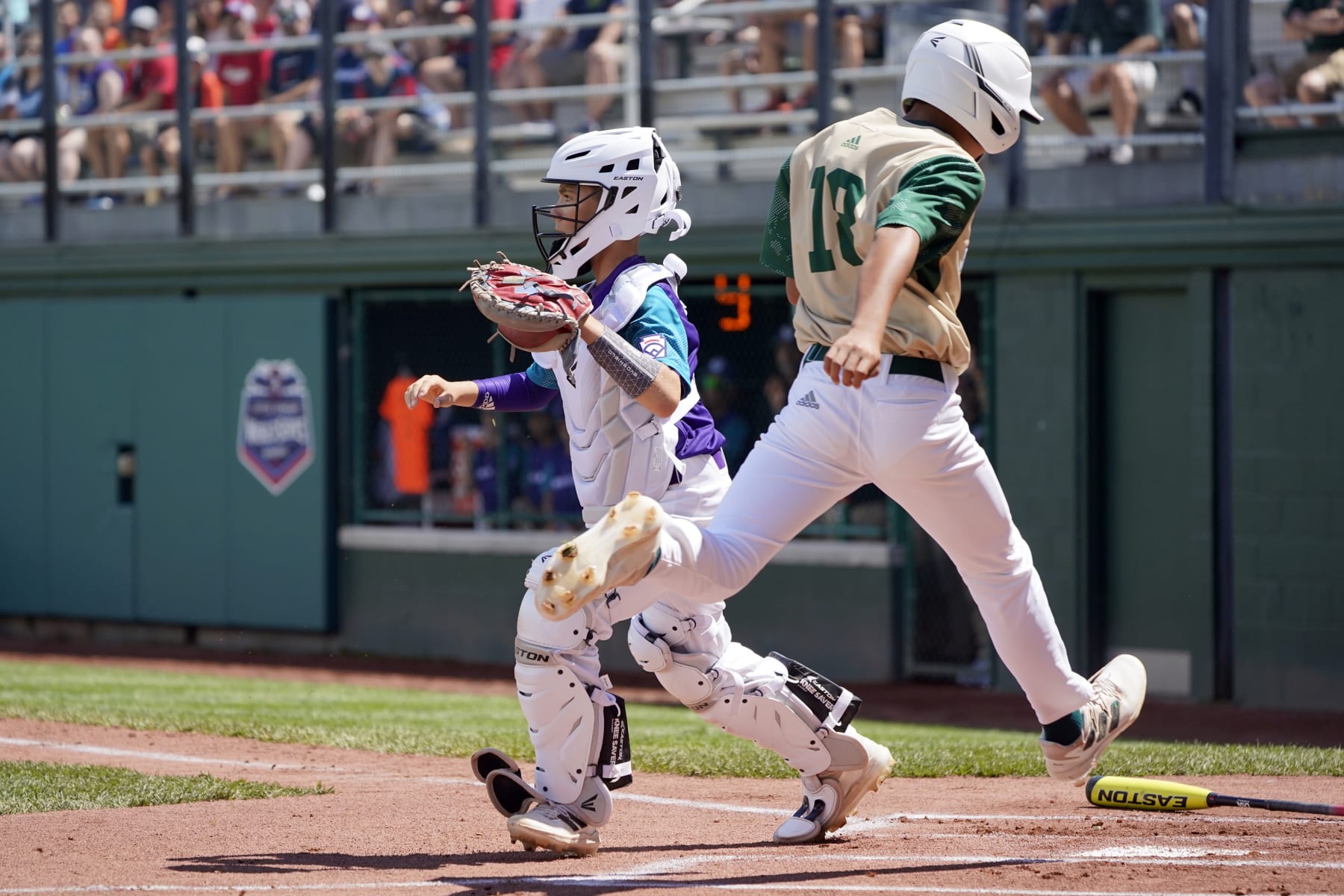 Taiwan's Liao Yuan-Shu (18) scores in the first inning as Italy catcher Cristopher Zafferani covers the plate during the first inning of a baseball game at the Little League World Series tournament in South Williamsport, Pa., Thursday, Aug. 18, 2022. (AP Photo/Tom E. Puskar)