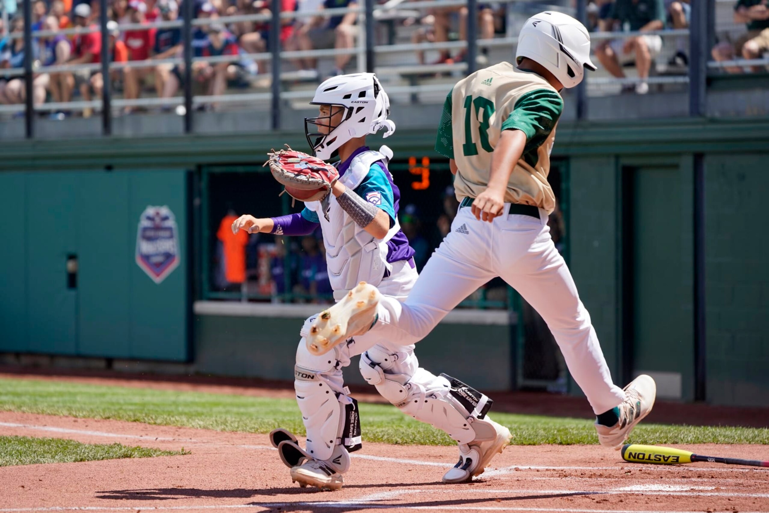 Taiwan's Liao Yuan-Shu (18) scores in the first inning as Italy catcher Cristopher Zafferani covers the plate during the first inning of a baseball game at the Little League World Series tournament in South Williamsport, Pa., Thursday, Aug. 18, 2022. (AP Photo/Tom E. Puskar)
