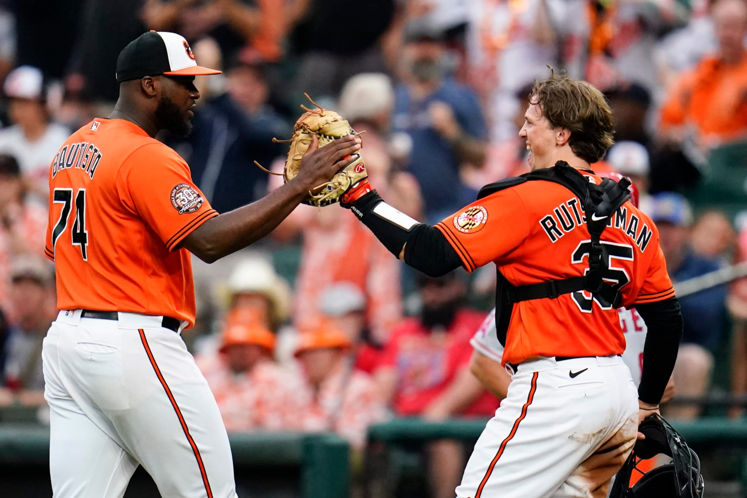 Baltimore Orioles relief pitcher Felix Bautista (74) and catcher Adley Rutschman (35) react after pitching to the Los Angeles Angels during the eighth inning of a baseball game, Saturday, July 9, 2022, in Baltimore. The Orioles won 1-0. (AP Photo/Julio Cortez)