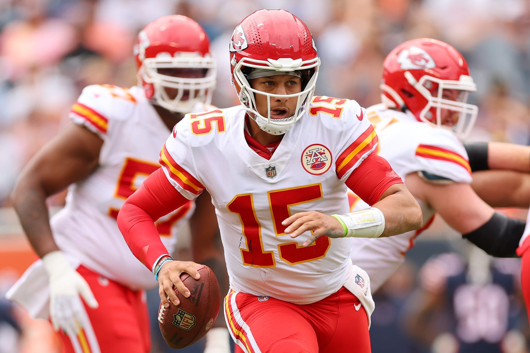 CHICAGO, ILLINOIS - AUGUST 13: Patrick Mahomes #15 of the Kansas City Chiefs scrambles with the ball against the Chicago Bears during the first half of the preseason game at Soldier Field on August 13, 2022 in Chicago, Illinois. (Photo by Michael Reaves/Getty Images)