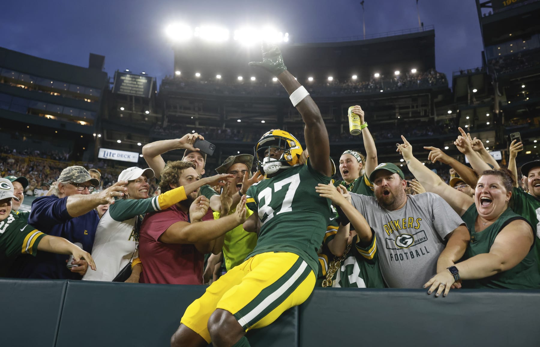 Green Bay Packers wide receiver Romeo Doubs (87) does a Lambeau leap after catching a touchdown pass over New Orleans Saints cornerback Brian Allen (37) during an NFL preseason football game Friday, Aug. 19, 2022, in Green Bay, Wis. (AP Photo/Jeffrey Phelps)