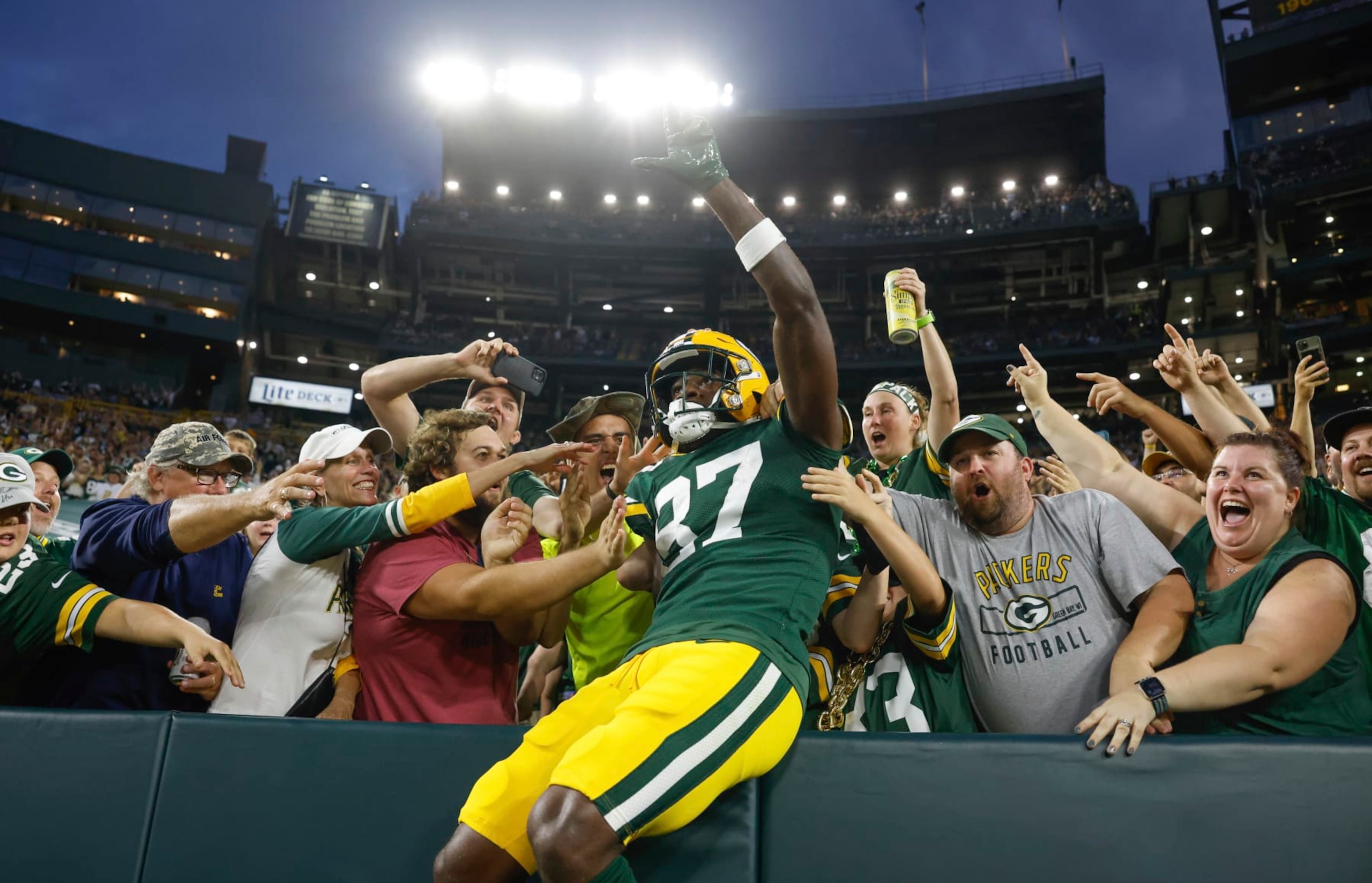 Green Bay Packers wide receiver Romeo Doubs (87) does a Lambeau leap after catching a touchdown pass over New Orleans Saints cornerback Brian Allen (37) during an NFL preseason football game Friday, Aug. 19, 2022, in Green Bay, Wis. (AP Photo/Jeffrey Phelps)