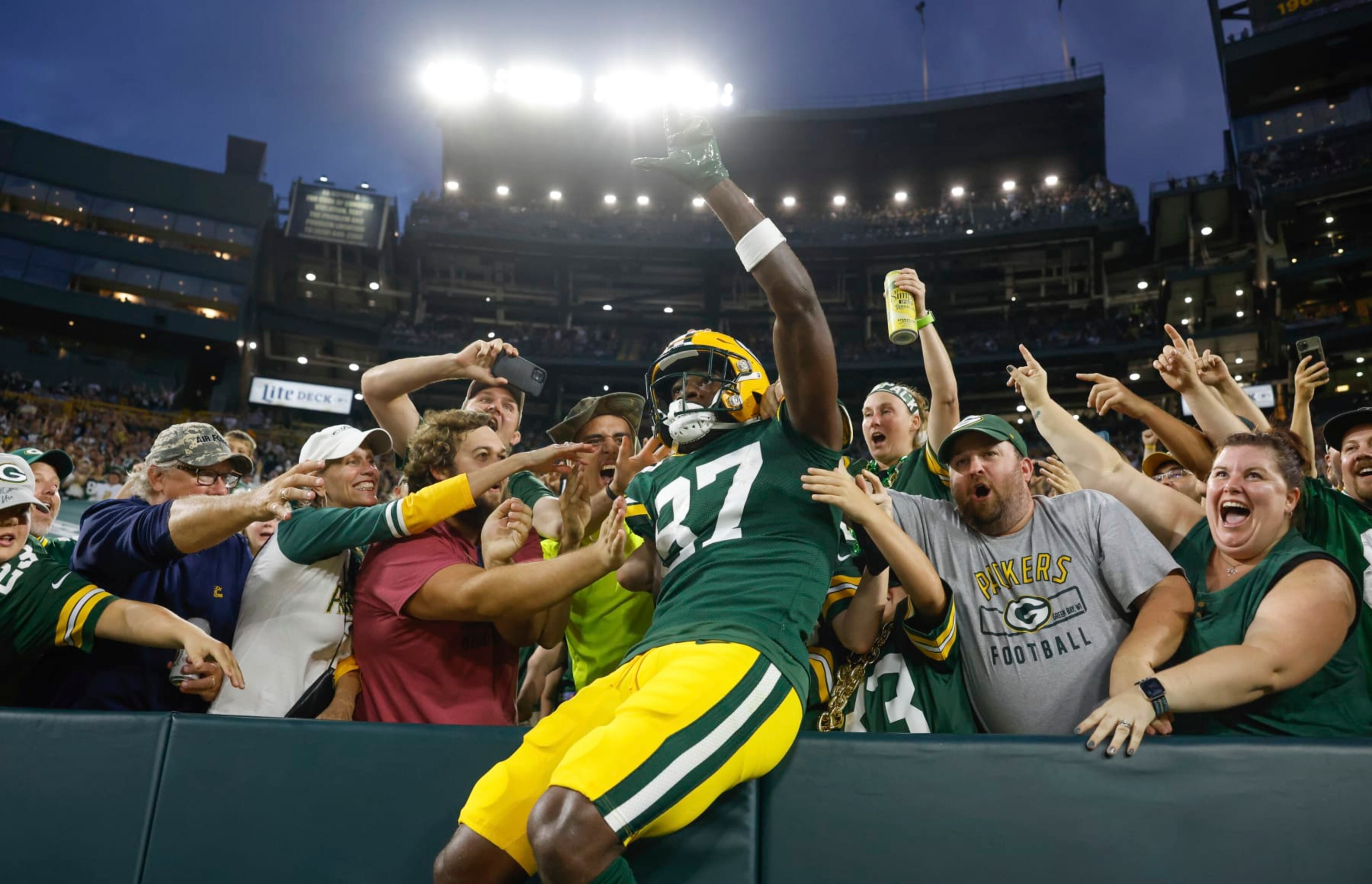 Green Bay Packers wide receiver Romeo Doubs (87) does a Lambeau leap after catching a touchdown pass over New Orleans Saints cornerback Brian Allen (37) during an NFL preseason football game Friday, Aug. 19, 2022, in Green Bay, Wis. (AP Photo/Jeffrey Phelps)