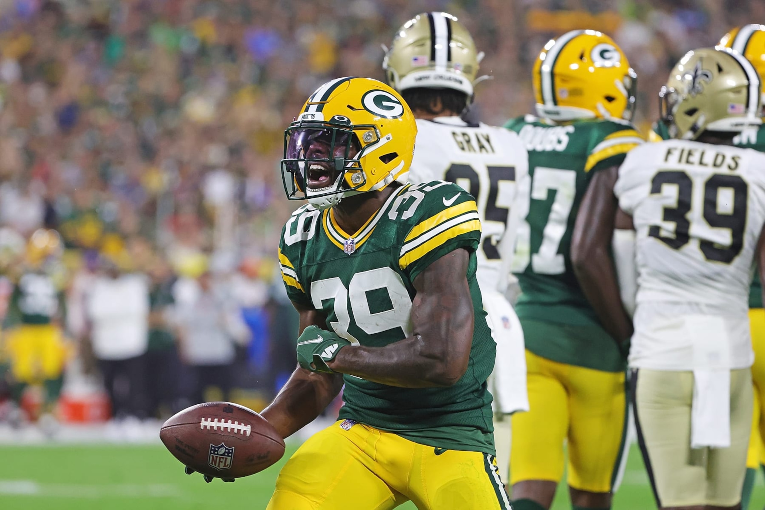 GREEN BAY, WISCONSIN - AUGUST 19: Tyler Goodson #39 of the Green Bay Packers reacts to a first down against the New Orleans Saints during the first half of a preseason game at Lambeau Field on August 19, 2022 in Green Bay, Wisconsin. (Photo by Stacy Revere/Getty Images)