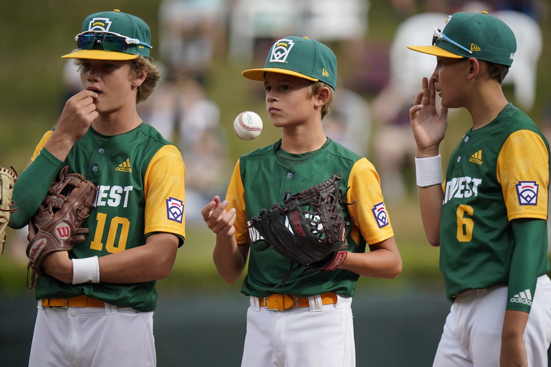 Davenport, Iowa's Blake Bishop, center, waits for a play to be reviewed with teammates Mason McFate (10) and Jameson Andresen (6) during the first inning of a baseball game against Hagerstown, Ind., at the Little League World Series in South Williamsport, Pa., Thursday, Aug. 18, 2022. (AP Photo/Gene J. Puskar)