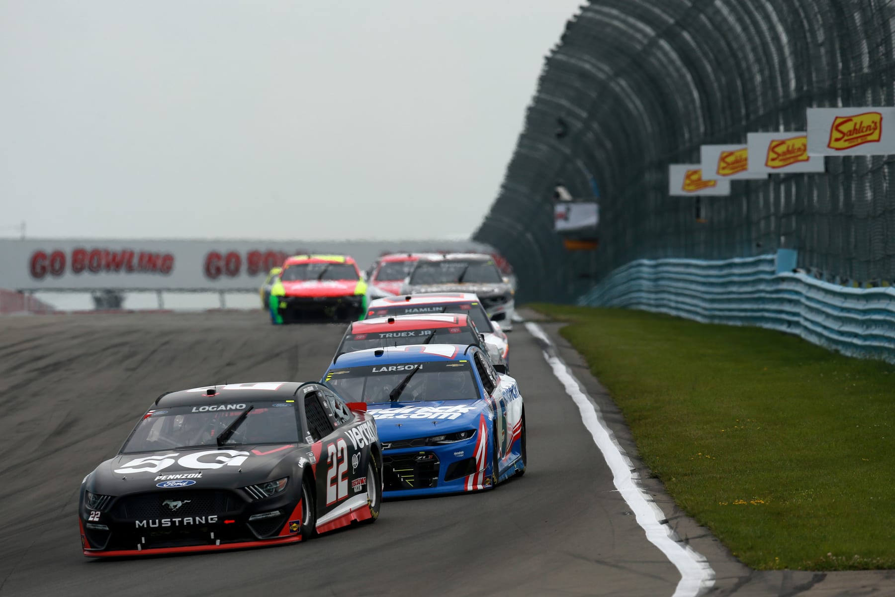 WATKINS GLEN, NEW YORK - AUGUST 08: Joey Logano, driver of the #22 Verizon 5G Ford, and Kyle Larson, driver of the #5 HendrickCars.com Chevrolet, race during the NASCAR Cup Series Go Bowling at The Glen at Watkins Glen International on August 08, 2021 in Watkins Glen, New York. (Photo by Sean Gardner/Getty Images)