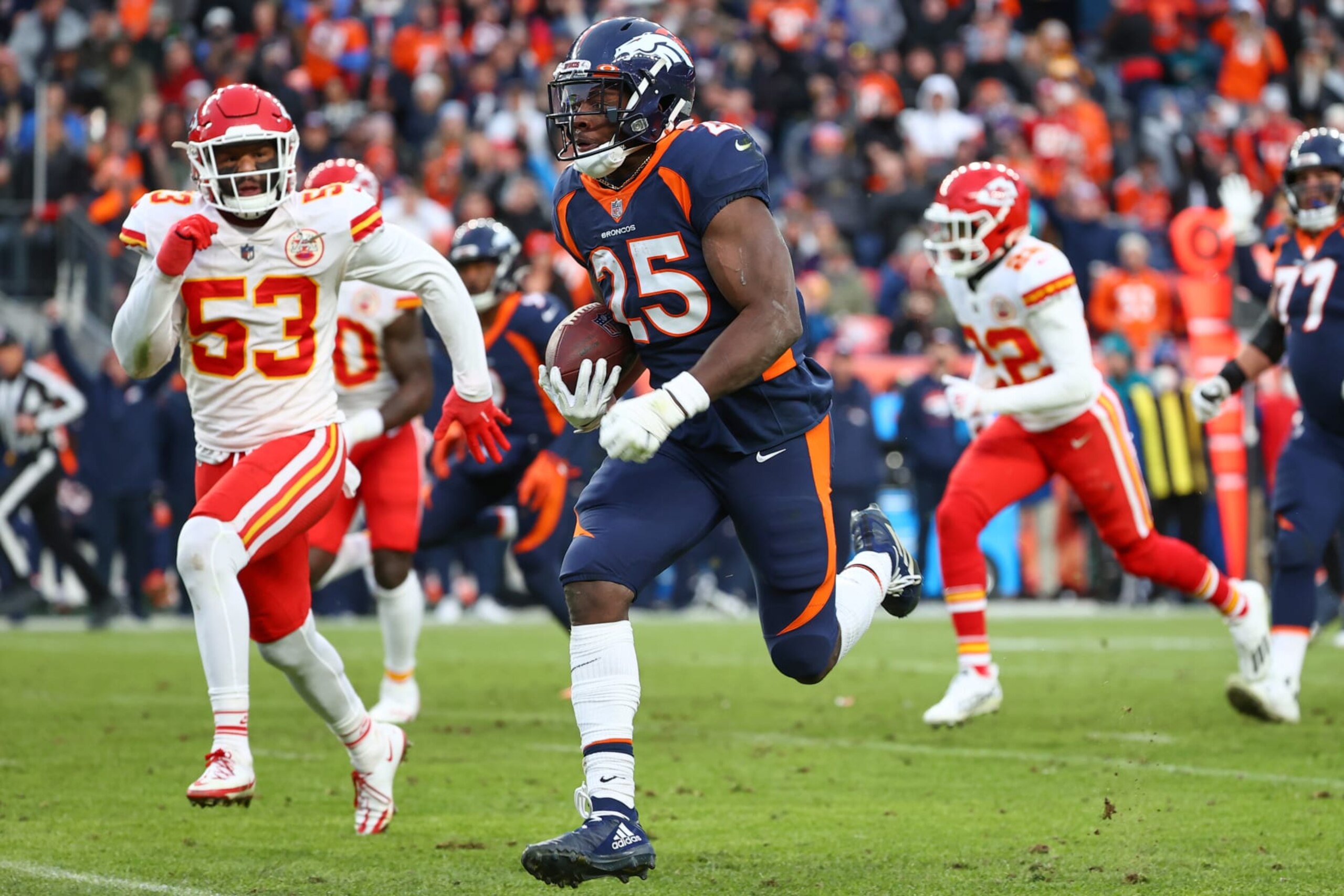 DENVER, COLORADO - JANUARY 08: Melvin Gordon #25 of the Denver Broncos rushes for a touchdown during the third quarter against the Kansas City Chiefs at Empower Field At Mile High on January 08, 2022 in Denver, Colorado. (Photo by Jamie Schwaberow/Getty Images)