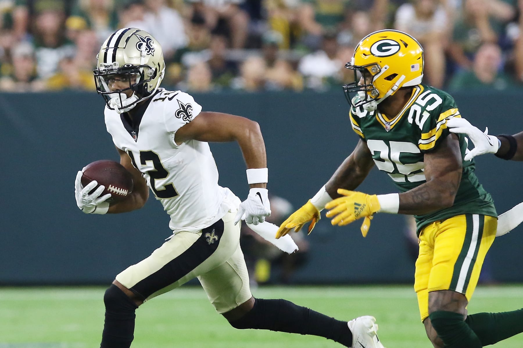 GREEN BAY, WI - AUGUST 19: Green Bay Packers cornerback Keisean Nixon (25) chase down New Orleans Saints wide receiver Chris Olave (12) during an NFL preseason game between the Green Bay Packers and the New Orleans Saints on August 19, 2022, at Lambeau Field in Green Bay, WI. (Photo by Larry Radloff/Icon Sportswire via Getty Images)
