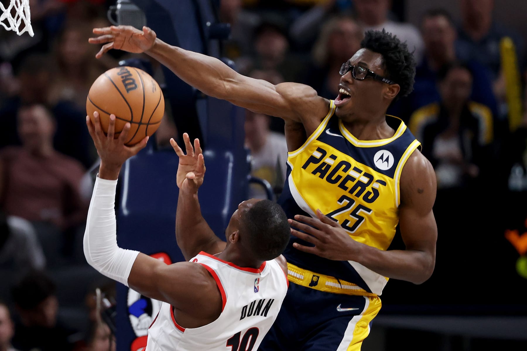 INDIANAPOLIS, INDIANA - MARCH 20: Kris Dunn #18 of the Portland Trail Blazers attempts a shot while being guarded by Jalen Smith #25 of the Indiana Pacers in the second quarter at Gainbridge Fieldhouse on March 20, 2022 in Indianapolis, Indiana. NOTE TO USER: User expressly acknowledges and agrees that, by downloading and or using this Photograph, user is consenting to the terms and conditions of the Getty Images License Agreement. (Photo by Dylan Buell/Getty Images)