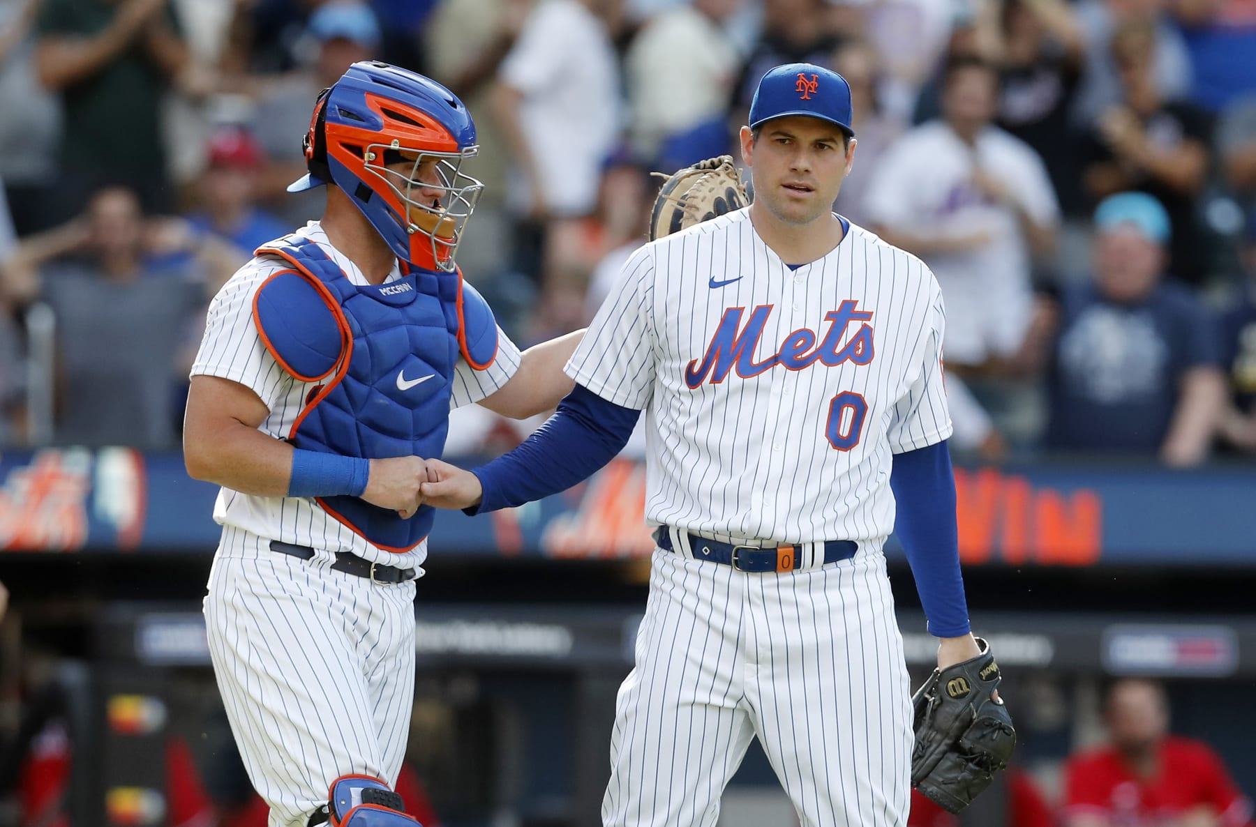 NEW YORK, NEW YORK - AUGUST 14:  Adam Ottavino #0 and James McCann #33 of the New York Mets celebrate after defeating the Philadelphia Phillies at Citi Field on August 14, 2022 in New York City. (Photo by Jim McIsaac/Getty Images)