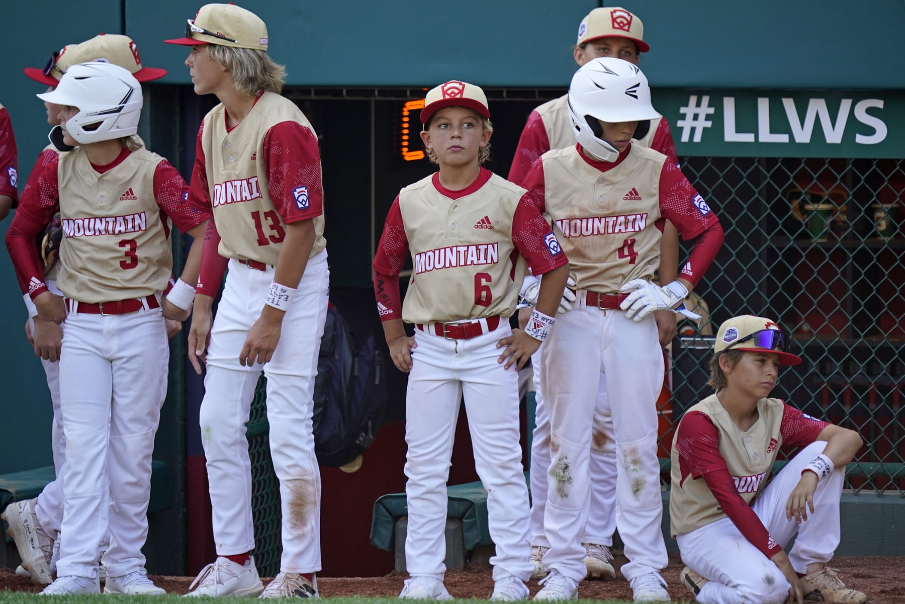 Santa Clara, Utah's Brogan Oliverson (6) waits with teammates for the post-game handshake line following a baseball game against Nolensville, Tenn., at the Little League World Series in South Williamsport, Pa., Friday, Aug. 19, 2022. Tennessee won 11-2. Brogan was taking the place of his brother Easton on the team after Easton was injured when he fell out of his bunk. (AP Photo/Gene J. Puskar)