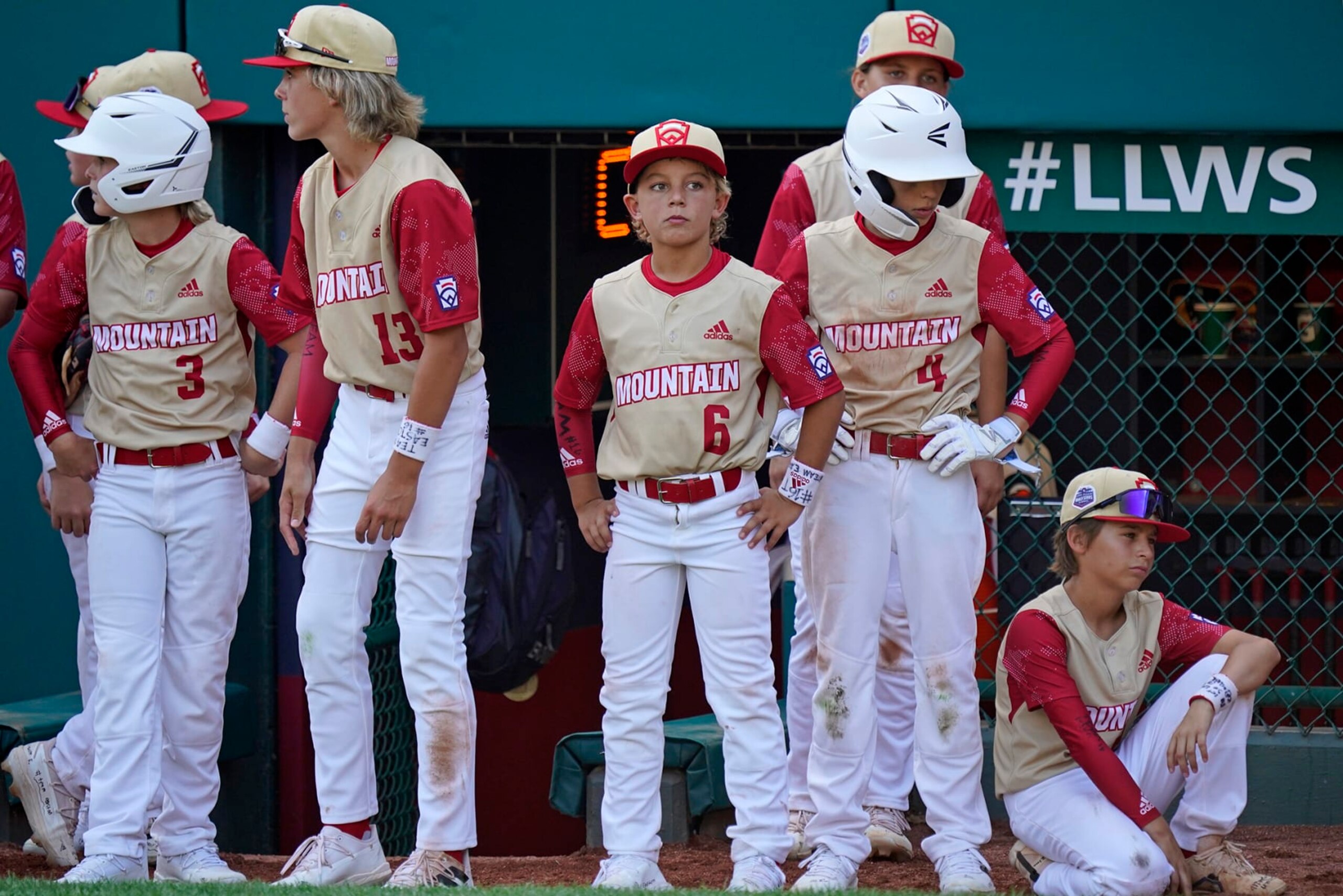 Santa Clara, Utah's Brogan Oliverson (6) waits with teammates for the post-game handshake line following a baseball game against Nolensville, Tenn., at the Little League World Series in South Williamsport, Pa., Friday, Aug. 19, 2022. Tennessee won 11-2. Brogan was taking the place of his brother Easton on the team after Easton was injured when he fell out of his bunk. (AP Photo/Gene J. Puskar)