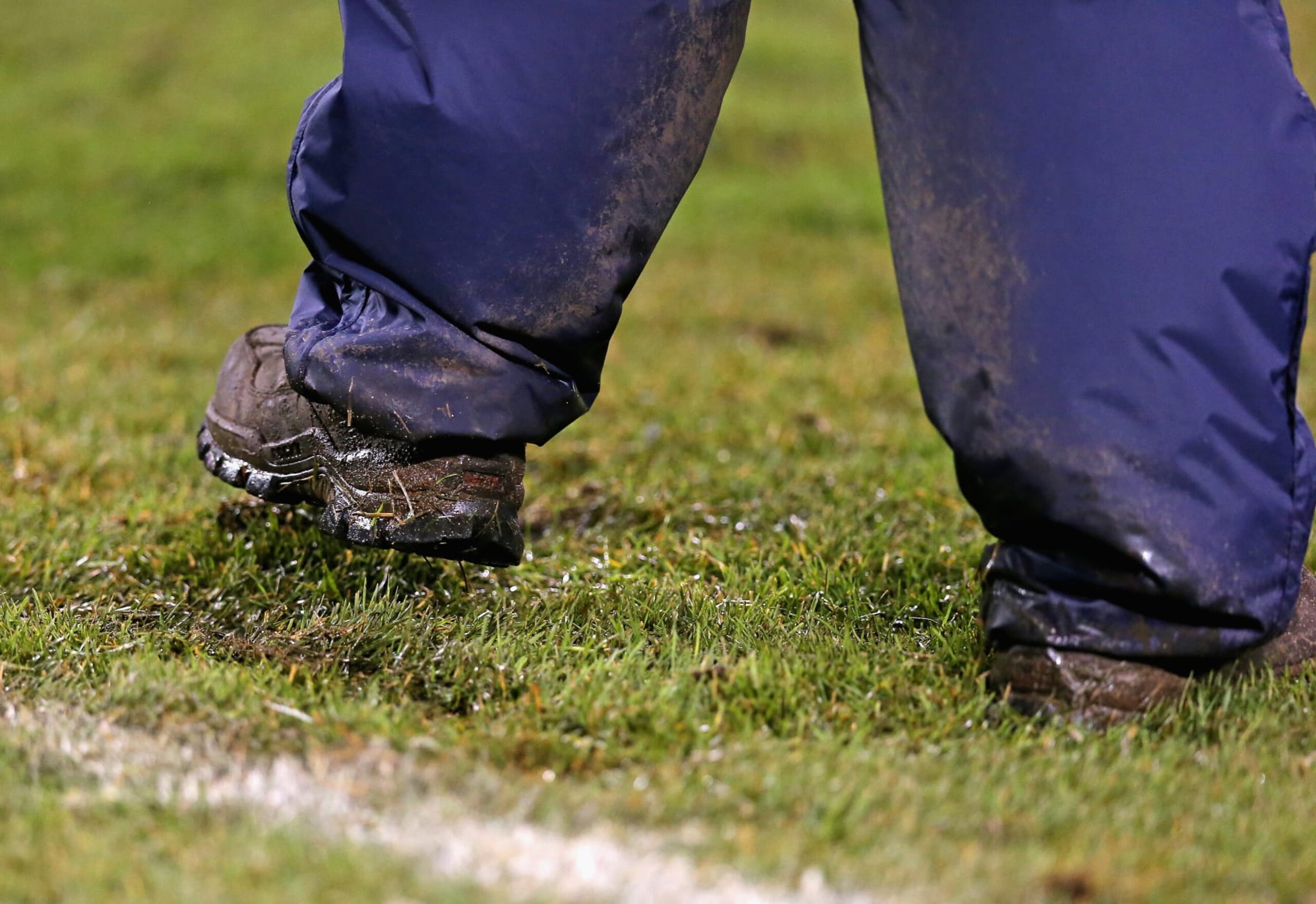 CHICAGO, IL - NOVEMBER 17: A worker from the Chicago Park Distrct tries to stomp down grass at Soldier Field during a game between the Chicago Bears and the Baltimore Ravens at Soldier Field on November 17, 2013 in Chicago, Illinois. The Bears defeated the Ravens 23-20 in overtime. (Photo by Jonathan Daniel/Getty Images)