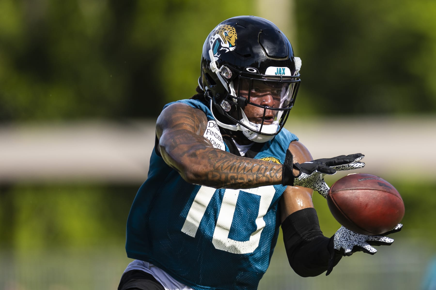 JACKSONVILLE, FLORIDA - JULY 26: Laviska Shenault Jr. #10 of the Jacksonville Jaguars catches a pass during Training camp on July 26, 2022 at Episcopal High School in Jacksonville, Florida. (Photo by James Gilbert/Getty Images)