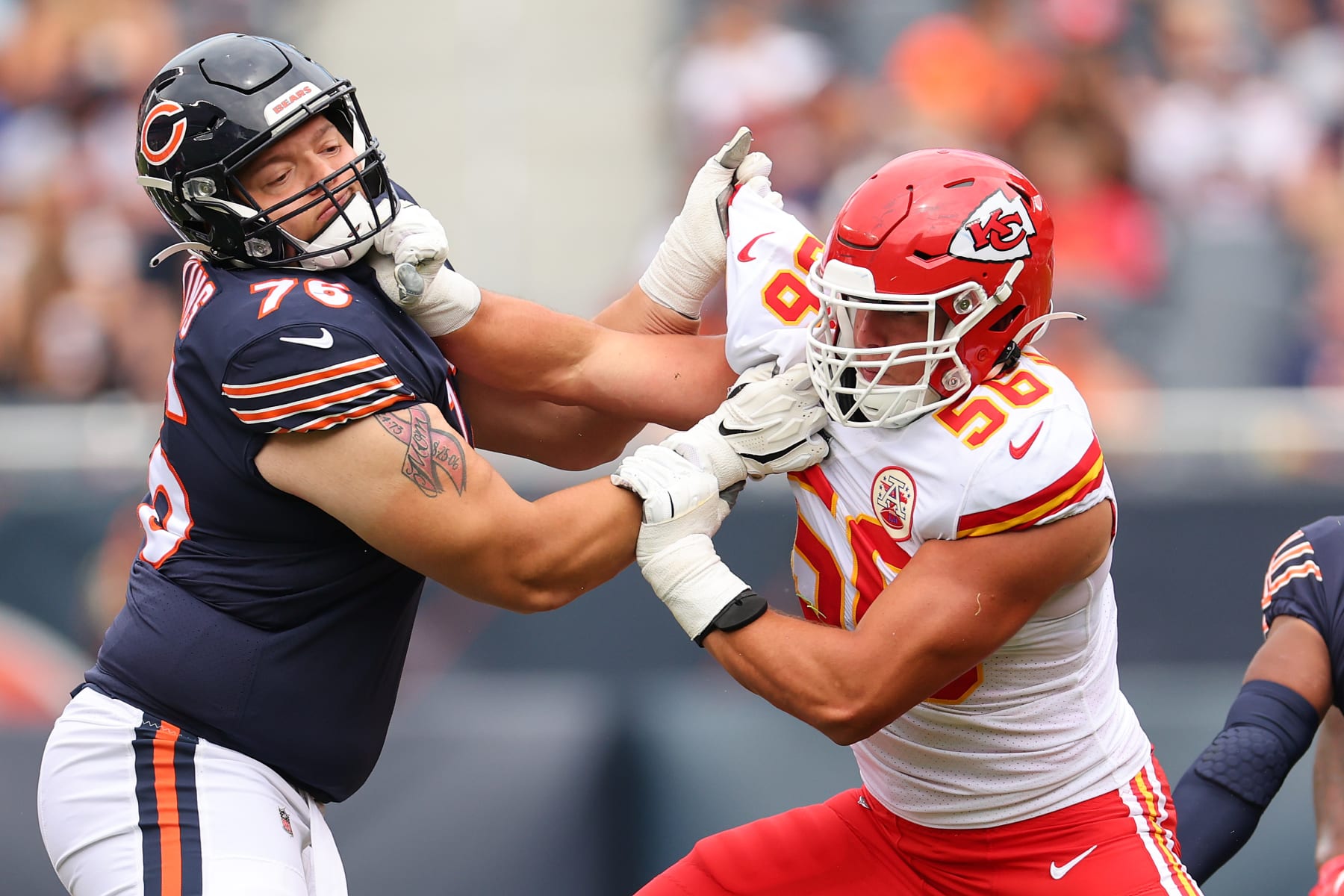CHICAGO, ILLINOIS - AUGUST 13: George Karlaftis #56 of the Kansas City Chiefs is defended by Teven Jenkins #76 of the Chicago Bears during the first half of the preseason game at Soldier Field on August 13, 2022 in Chicago, Illinois. (Photo by Michael Reaves/Getty Images)