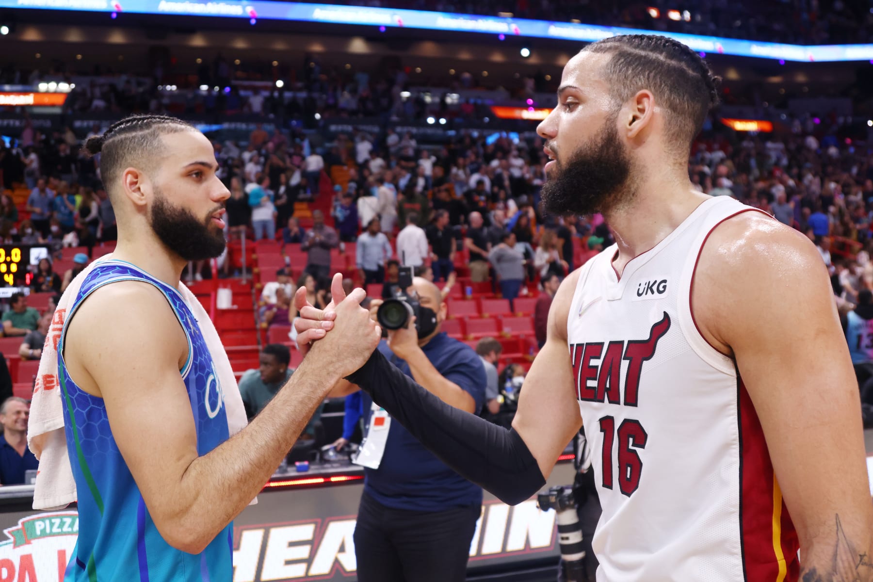 MIAMI, FLORIDA - APRIL 05: Cody Martin #11 of the Charlotte Hornets greets Caleb Martin #16 of the Miami Heat after the game at FTX Arena on April 05, 2022 in Miami, Florida. NOTE TO USER: User expressly acknowledges and agrees that, by downloading and or using this photograph, User is consenting to the terms and conditions of the Getty Images License Agreement.  (Photo by Michael Reaves/Getty Images)
