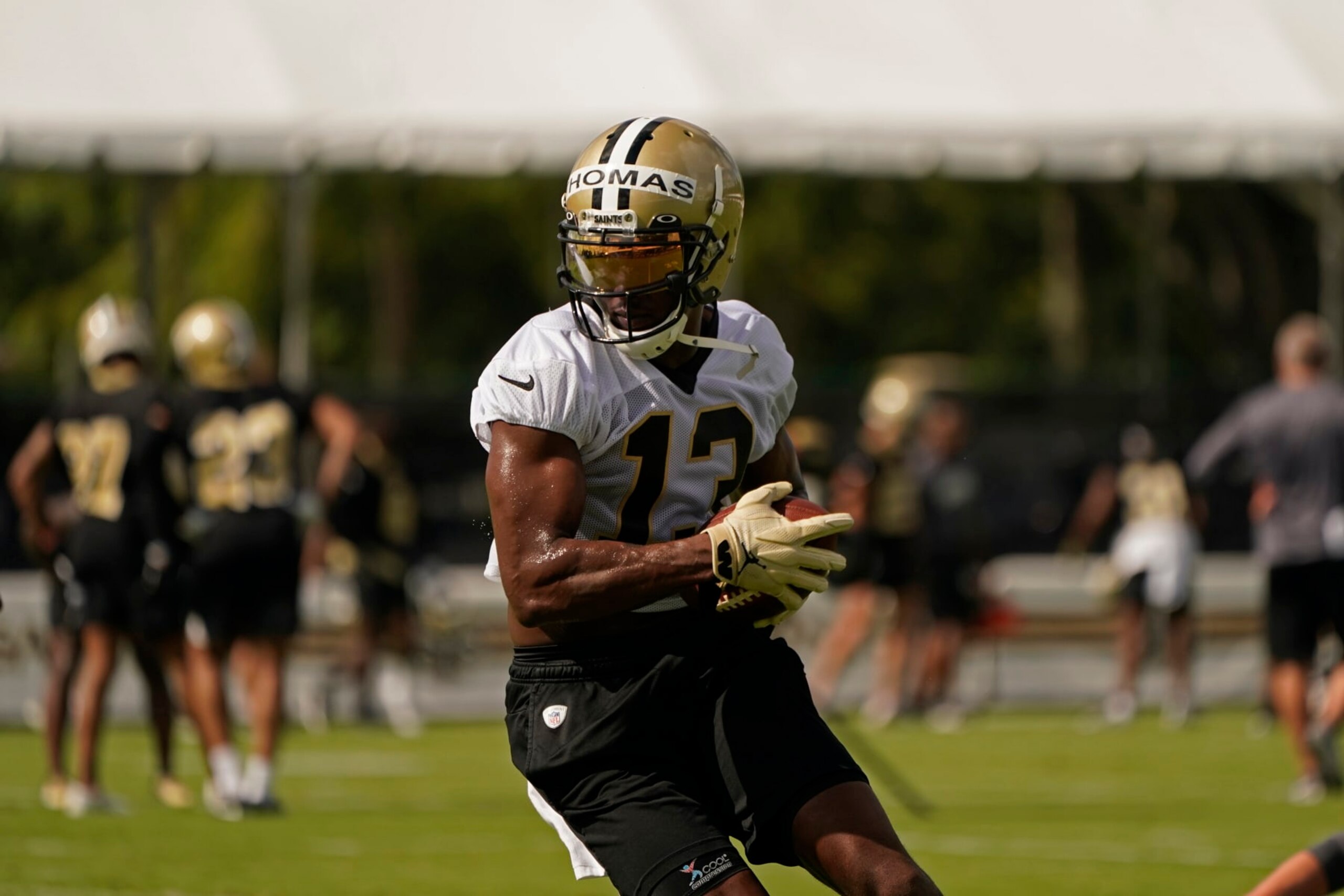 New Orleans Saints wide receiver Michael Thomas (13) runs though drills during training camp at their NFL football training facility in Metairie, La., Wednesday, July 27, 2022. (AP Photo/Gerald Herbert)