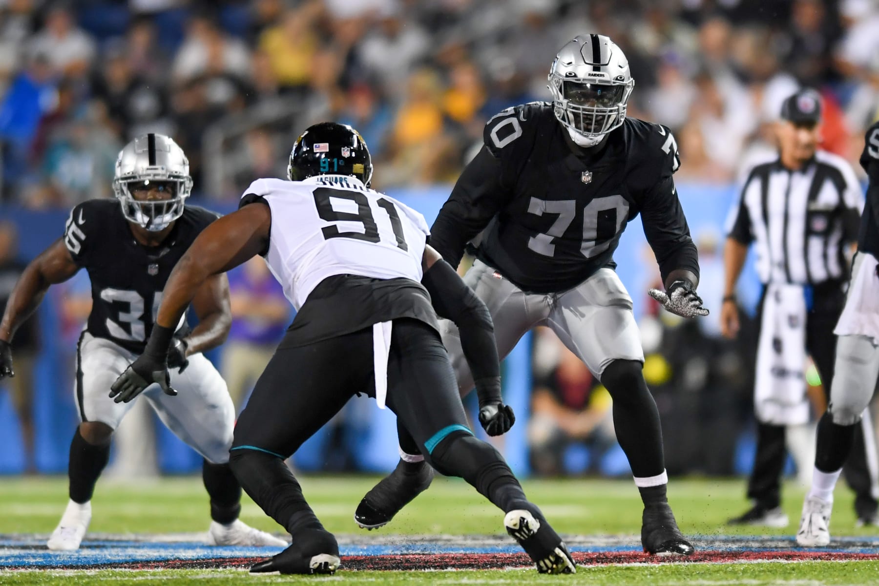 CANTON, OH - AUGUST 04: Alex Leatherwood #70 of the Las Vegas Raiders blocks Dawuane Smoot #91 of the Jacksonville Jaguars during the first half of the 2022 Pro Football Hall of Fame Game at Tom Benson Hall of Fame Stadium on August 04, 2022 in Canton, Ohio. (Photo by Nick Cammett/Diamond Images via Getty Images)