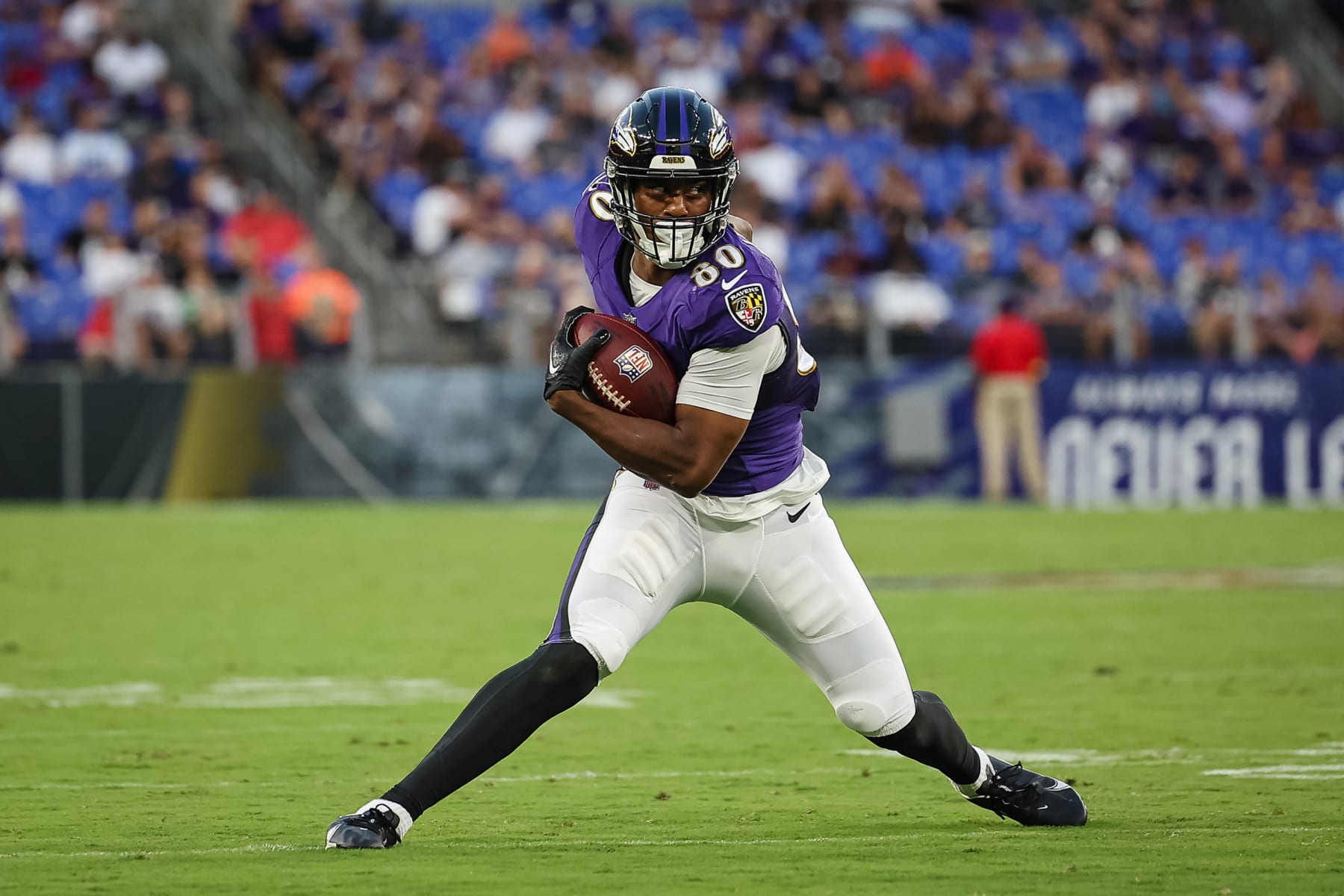 BALTIMORE, MD - AUGUST 11: Isaiah Likely #80 of the Baltimore Ravens carries the ball against the Tennessee Titans during the first half at M&T Bank Stadium on August 11, 2022 in Baltimore, Maryland. (Photo by Scott Taetsch/Getty Images)