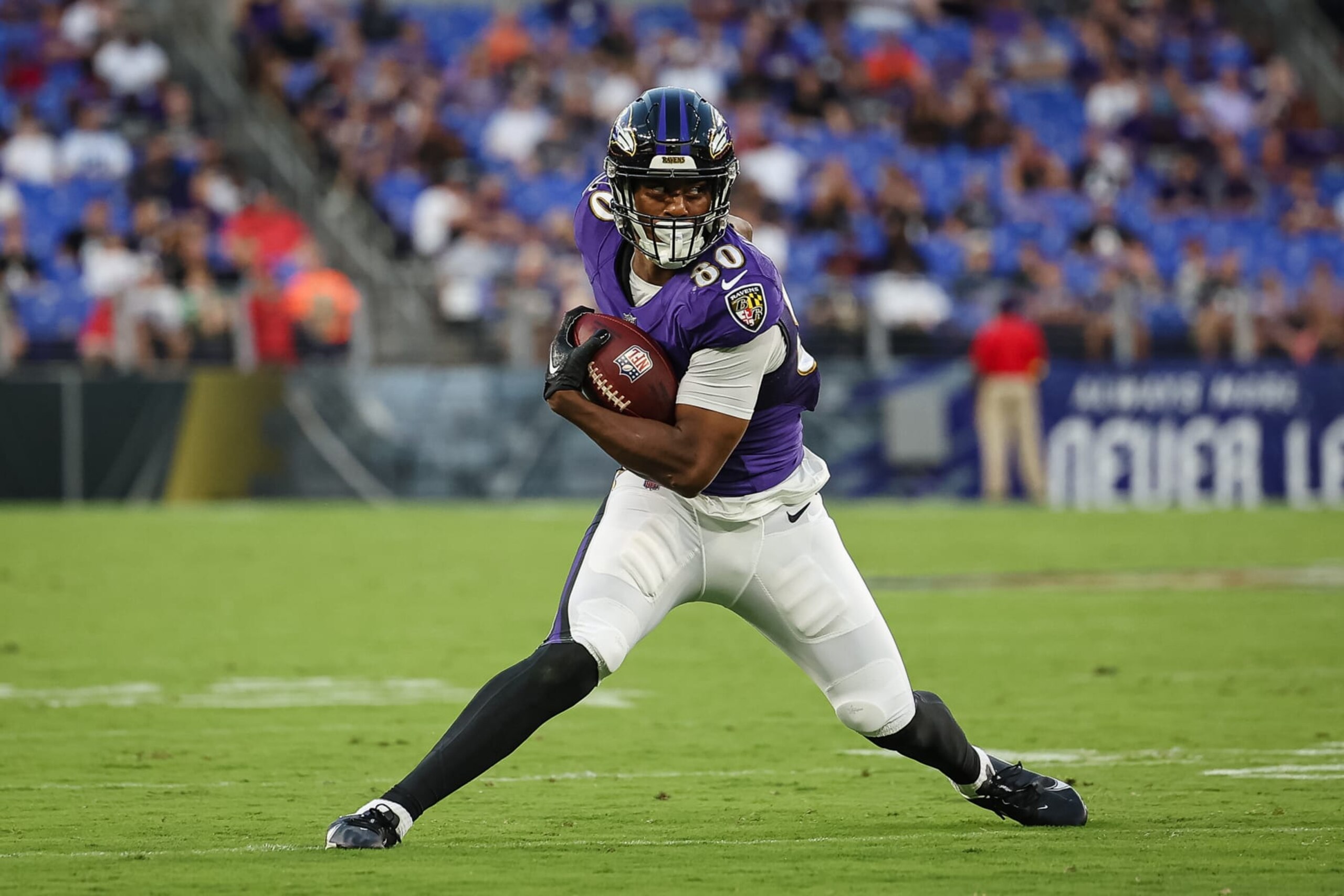 BALTIMORE, MD - AUGUST 11: Isaiah Likely #80 of the Baltimore Ravens carries the ball against the Tennessee Titans during the first half at M&T Bank Stadium on August 11, 2022 in Baltimore, Maryland. (Photo by Scott Taetsch/Getty Images)