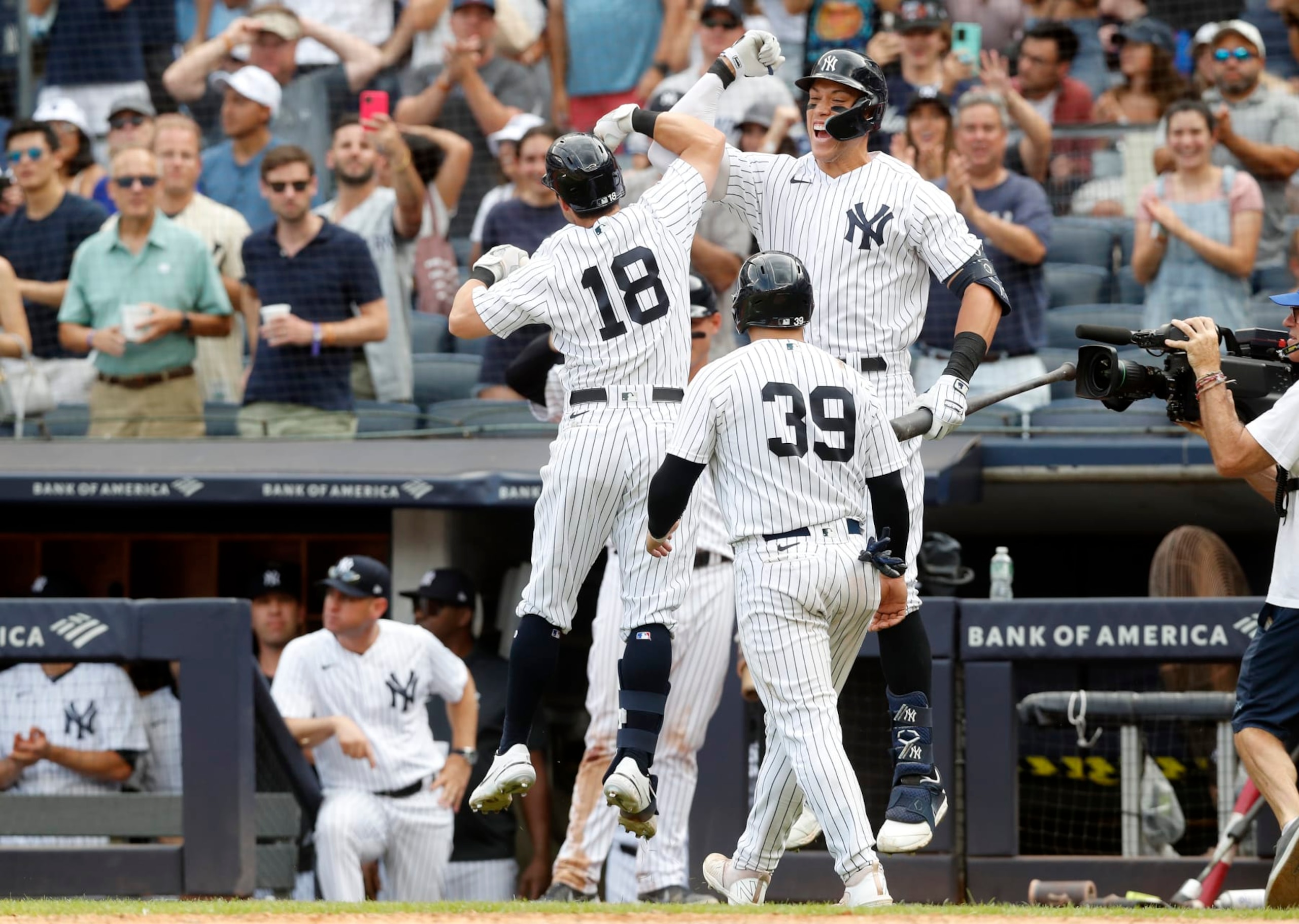 NEW YORK, NEW YORK - AUGUST 21:  Andrew Benintendi #18 of the New York Yankees celebrates his seventh inning two run home run against the Toronto Blue Jays with teammates Aaron Judge #99 and Jose Trevino #39 at Yankee Stadium on August 21, 2022 in New York City. (Photo by Jim McIsaac/Getty Images)