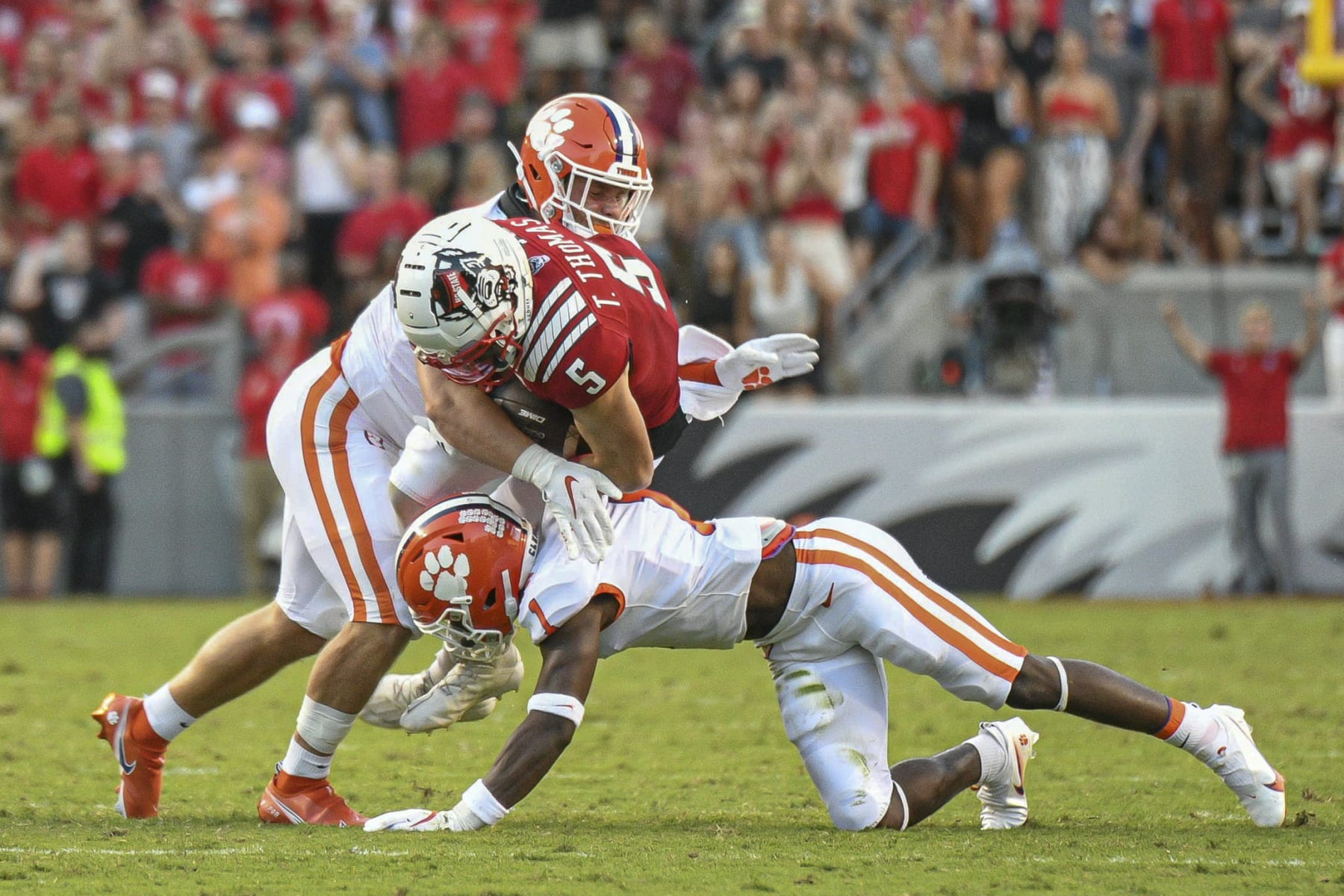 RALEIGH, NC - SEPTEMBER 25: North Carolina State Wolfpack wide receiver Thayer Thomas (5) is hit after a catch during the game between the Clemson Tigers and the NC State Wolfpack on September 25, 2021 at Carter-Finley Stadium in Raleigh, NC. (Photo by William Howard/Icon Sportswire via Getty Images)