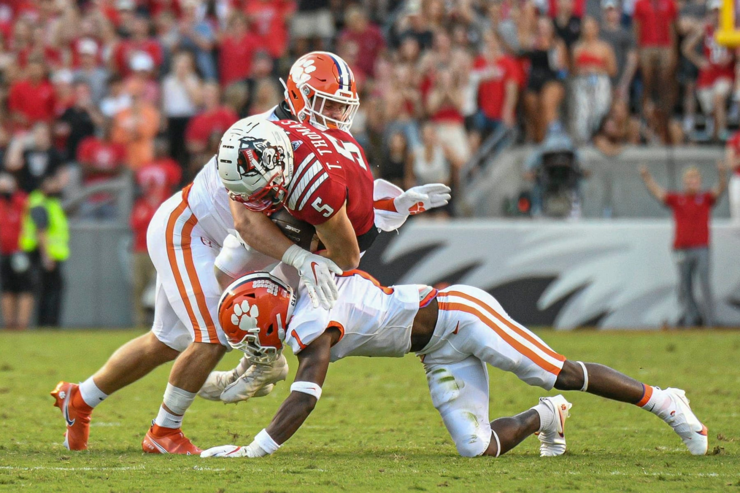 RALEIGH, NC - SEPTEMBER 25: North Carolina State Wolfpack wide receiver Thayer Thomas (5) is hit after a catch during the game between the Clemson Tigers and the NC State Wolfpack on September 25, 2021 at Carter-Finley Stadium in Raleigh, NC. (Photo by William Howard/Icon Sportswire via Getty Images) RALEIGH, NC - SEPTEMBER 25: North Carolina State Wolfpack wide receiver Thayer Thomas (5) is hit after a catch during the game between the Clemson Tigers and the NC State Wolfpack on September 25, 2021 at Carter-Finley Stadium in Raleigh, NC. (Photo by William Howard/Icon Sportswire via Getty Images)