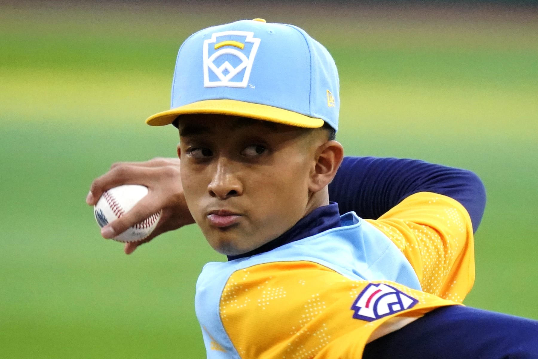 Honolulu's Jaron Lancaster delivers during the first inning of the team's baseball game against Massapequa, N.Y., at the Little League World Series in South Williamsport, Pa., Friday, Aug. 19, 2022. (AP Photo/Gene J. Puskar)
