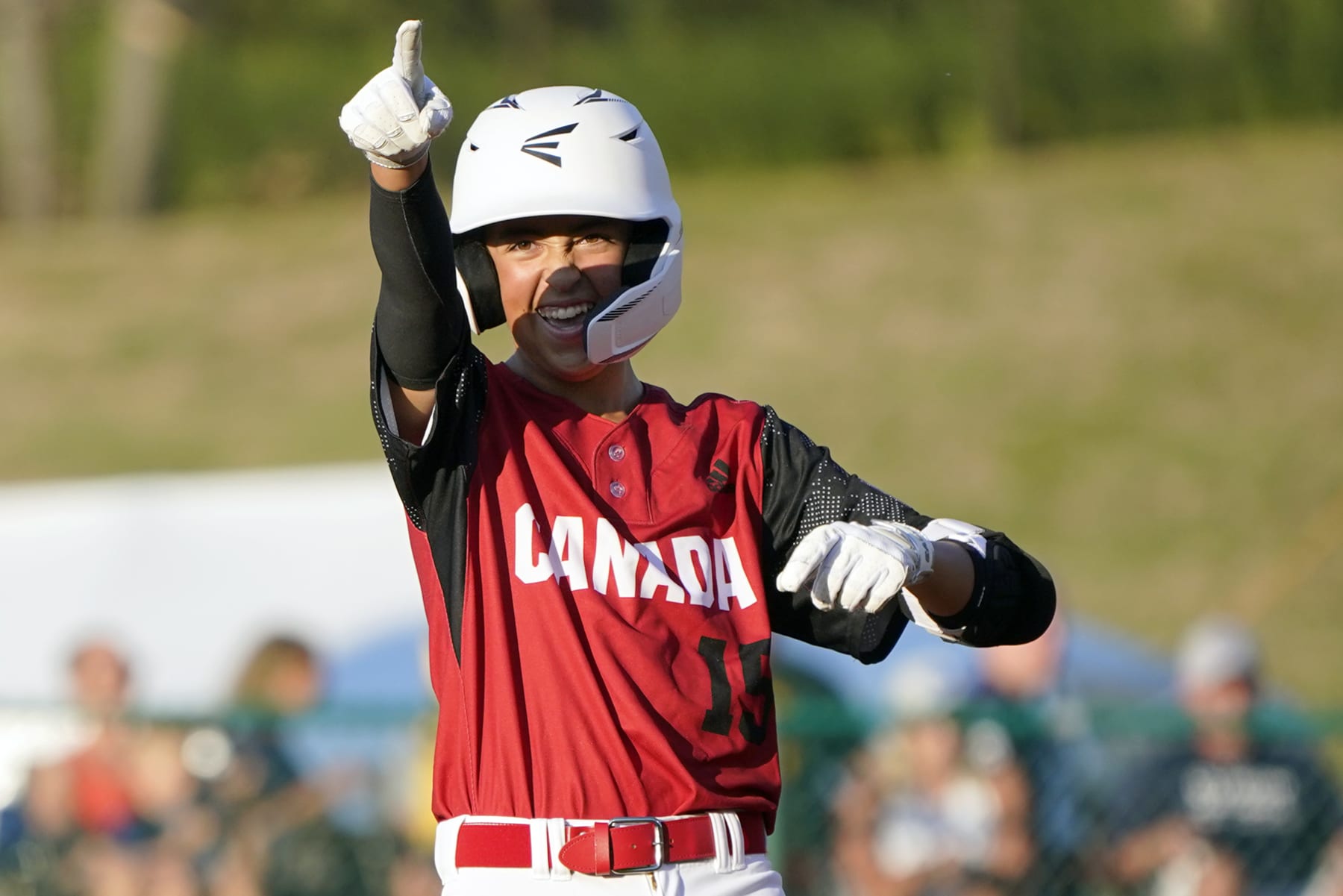 Canada's Benjamin Dartnel reacts after driving in three runs on his double against Japan during the sixth inning of a baseball game at the Little League World Series tournament in South Williamsport, Pa., Friday, Aug. 19, 2022. (AP Photo/Tom E. Puskar)