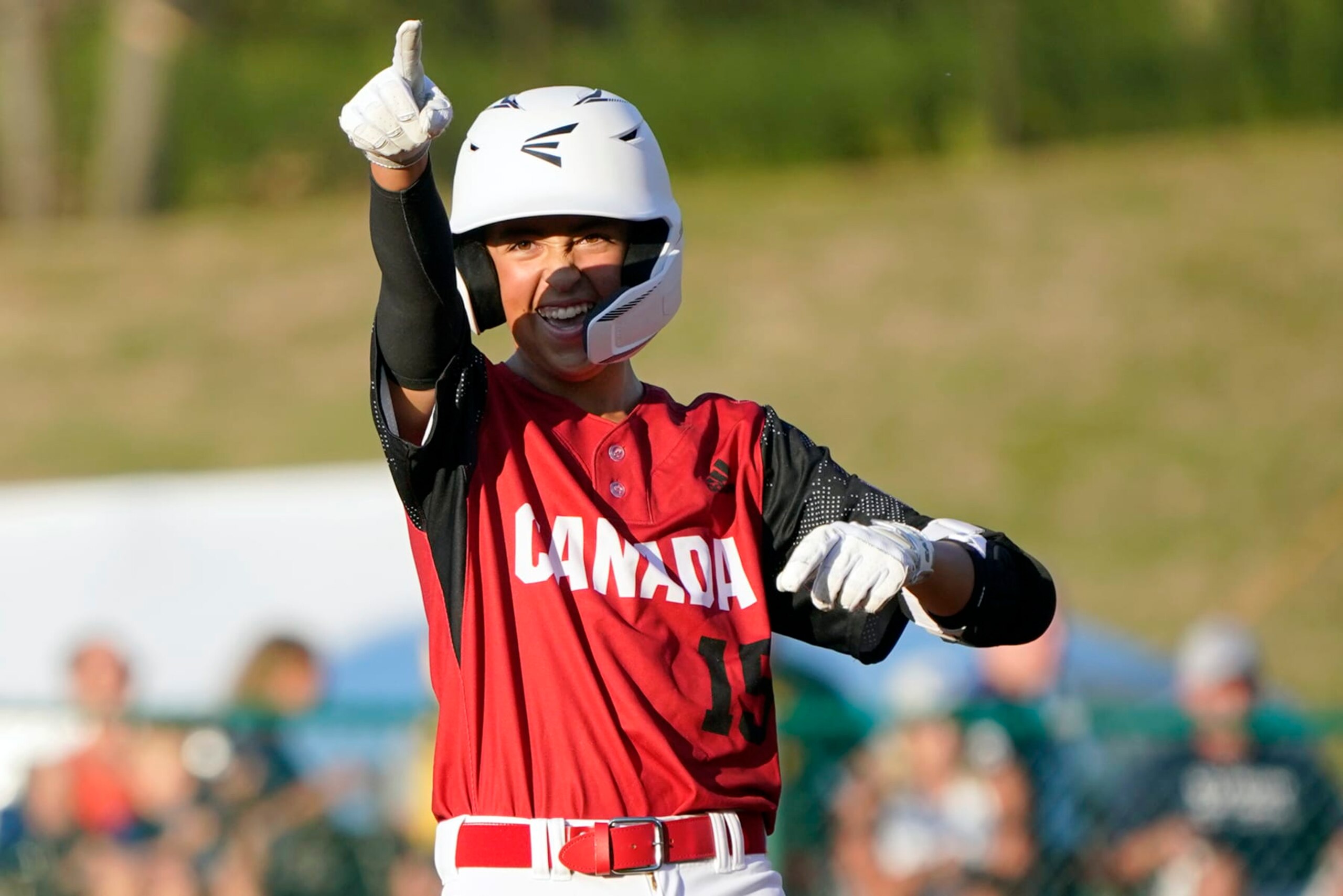 Canada's Benjamin Dartnel reacts after driving in three runs on his double against Japan during the sixth inning of a baseball game at the Little League World Series tournament in South Williamsport, Pa., Friday, Aug. 19, 2022. (AP Photo/Tom E. Puskar)