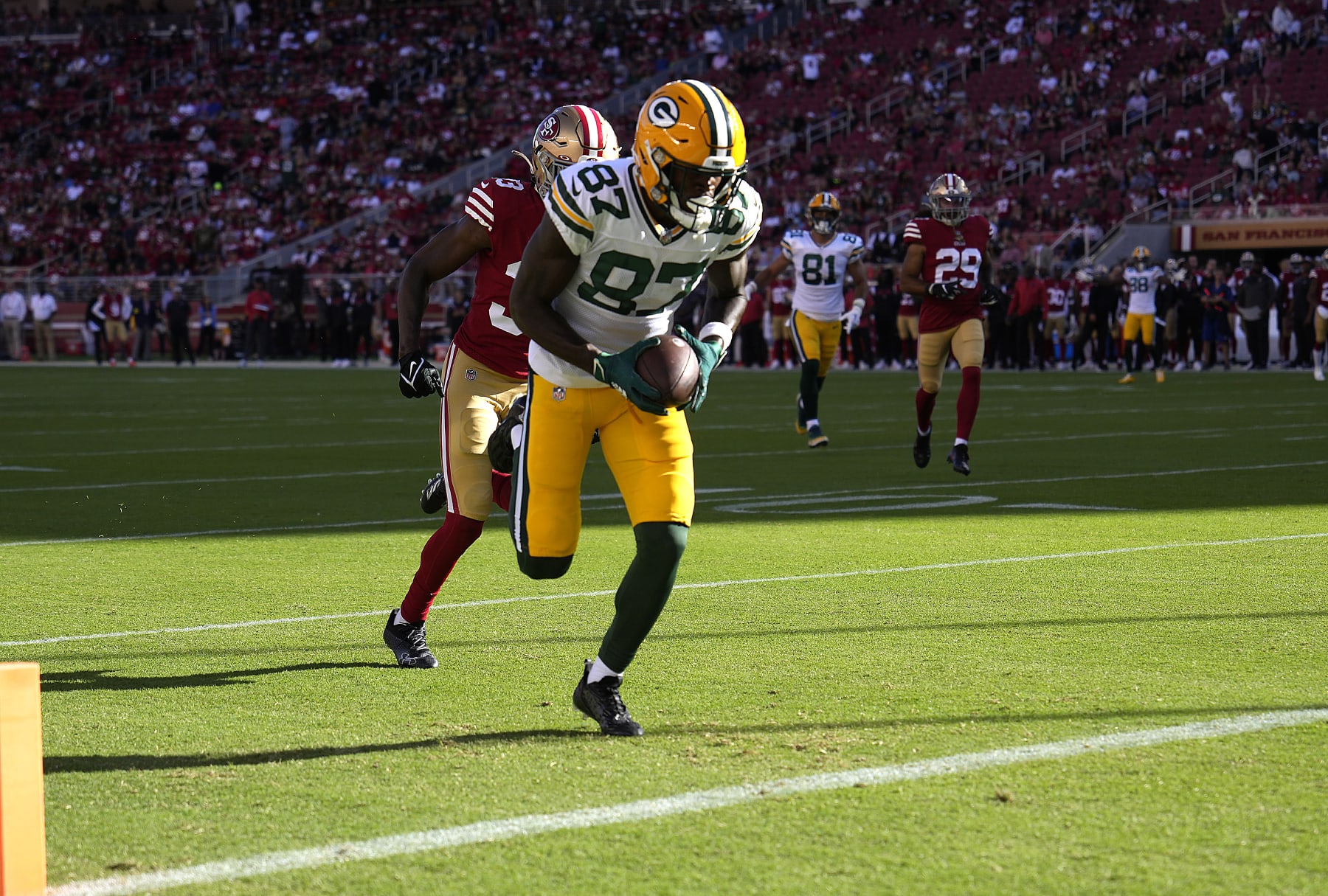 SANTA CLARA, CALIFORNIA - AUGUST 12: Romeo Doubs #87 of the Green Bay Packers catches a touchdown pass against the San Francisco 49ers during the first quarter of an NFL preseason football game at Levi's Stadium on August 12, 2022 in Santa Clara, California. (Photo by Thearon W. Henderson/Getty Images)