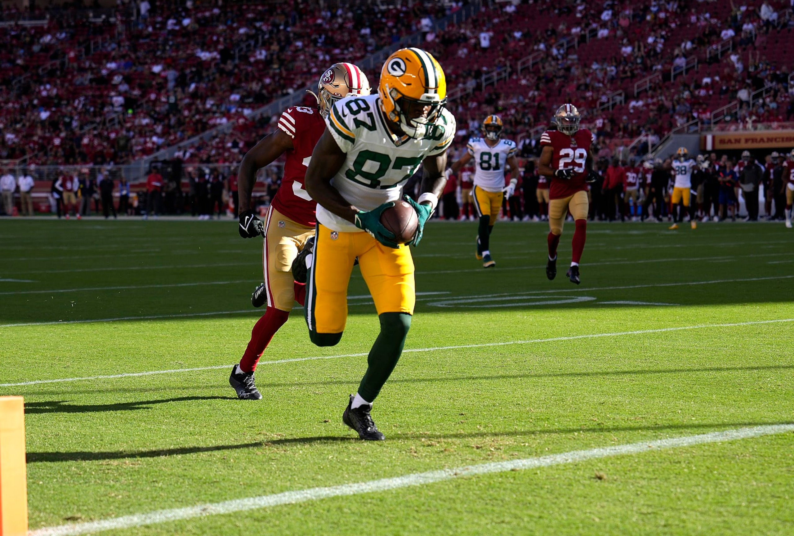SANTA CLARA, CALIFORNIA - AUGUST 12: Romeo Doubs #87 of the Green Bay Packers catches a touchdown pass against the San Francisco 49ers during the first quarter of an NFL preseason football game at Levi's Stadium on August 12, 2022 in Santa Clara, California. (Photo by Thearon W. Henderson/Getty Images)