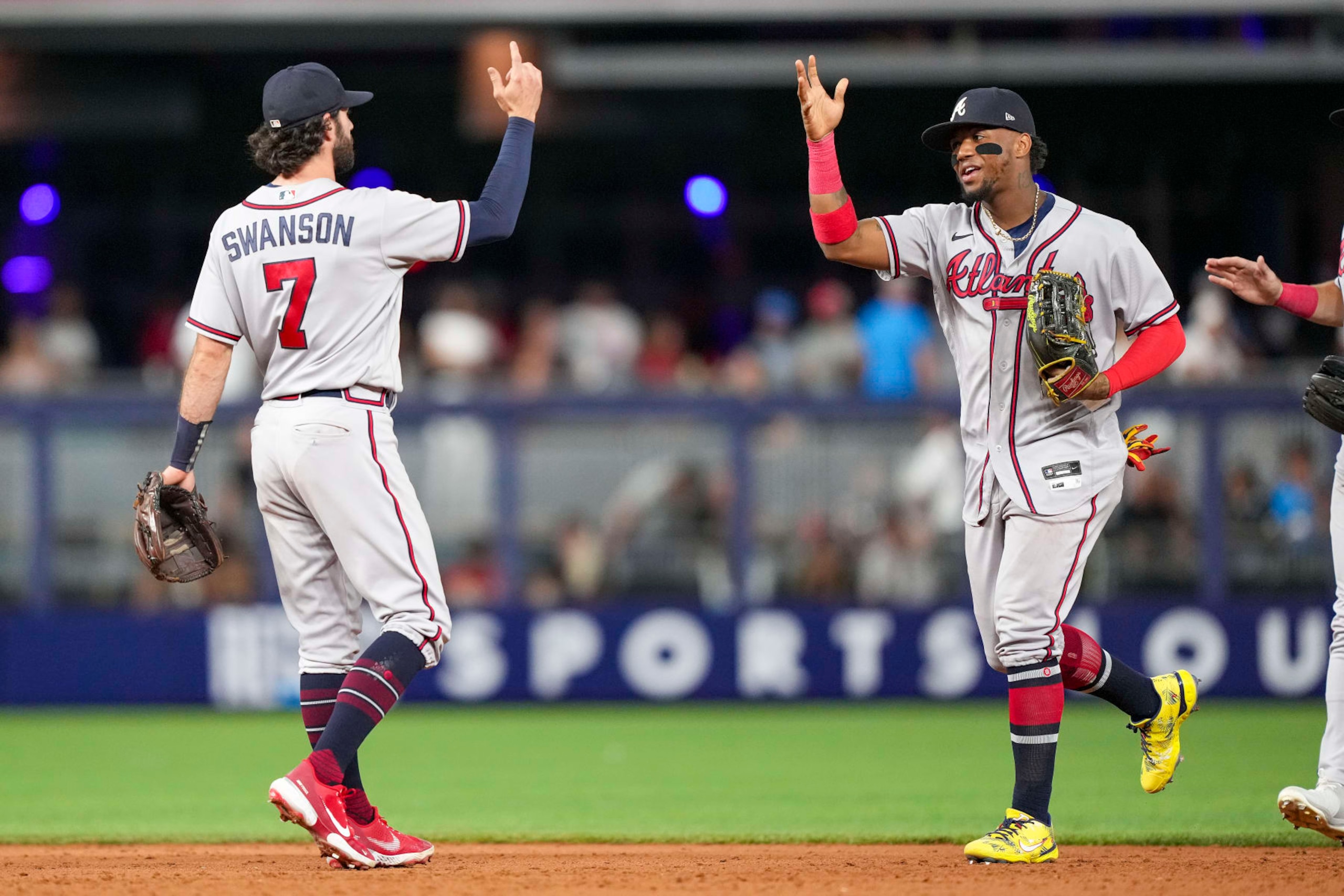MIAMI, FLORIDA - AUGUST 12: Dansby Swanson #7 of the Atlanta Braves celebrates with Ronald Acuna Jr. #13 after defeating the Miami Marlins at loanDepot park on August 12, 2022 in Miami, Florida. (Photo by Eric Espada/Getty Images)