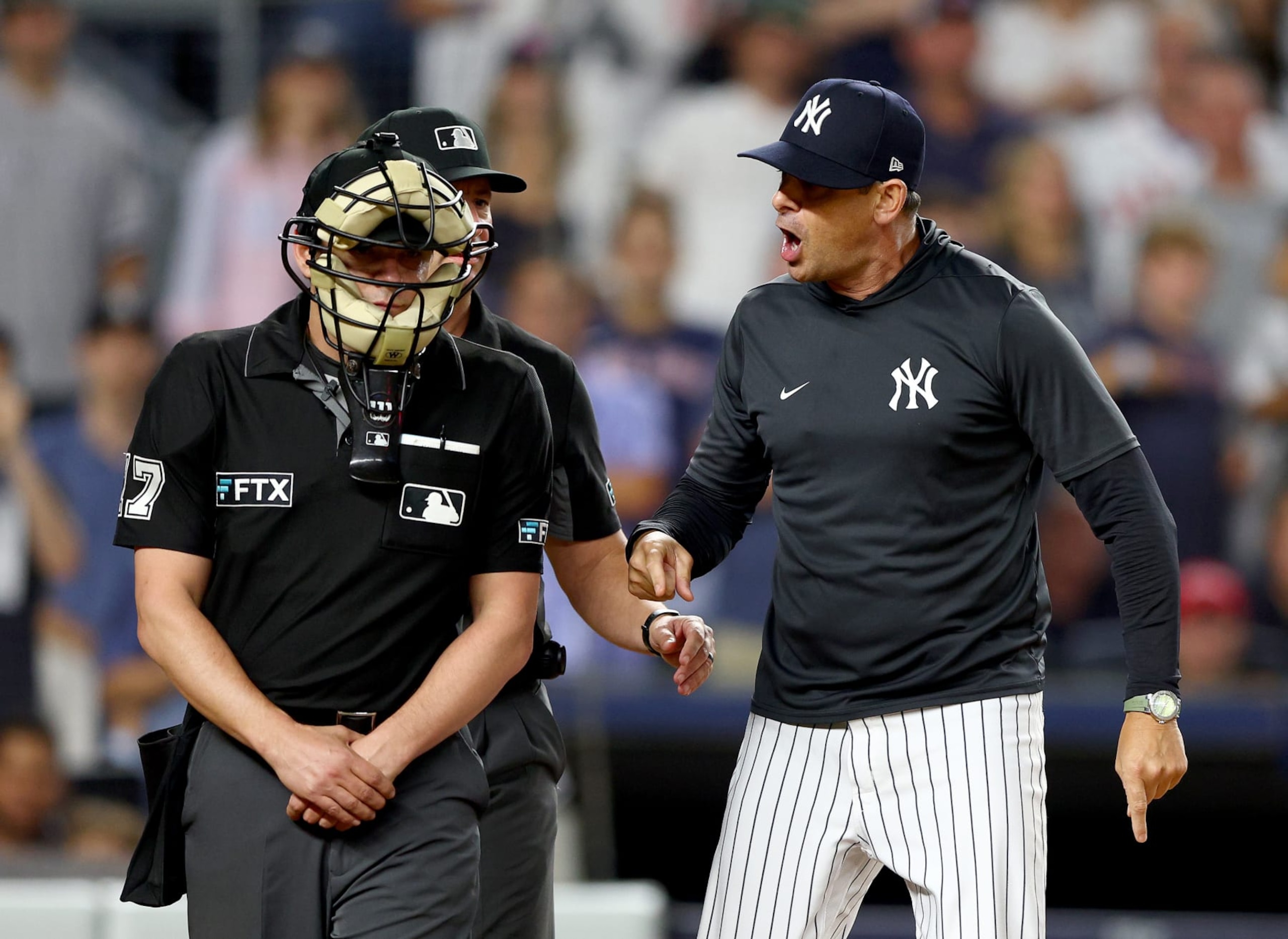 NEW YORK, NEW YORK - JULY 15:  Manager Aaron Boone #17 of the New York Yankees yells at home plate umpire D.J.Reyburn after Boone was tossed from the game in the ninth inning against the Boston Red Sox at Yankee Stadium on July 15, 2022 in the Bronx borough of New York City. (Photo by Elsa/Getty Images)