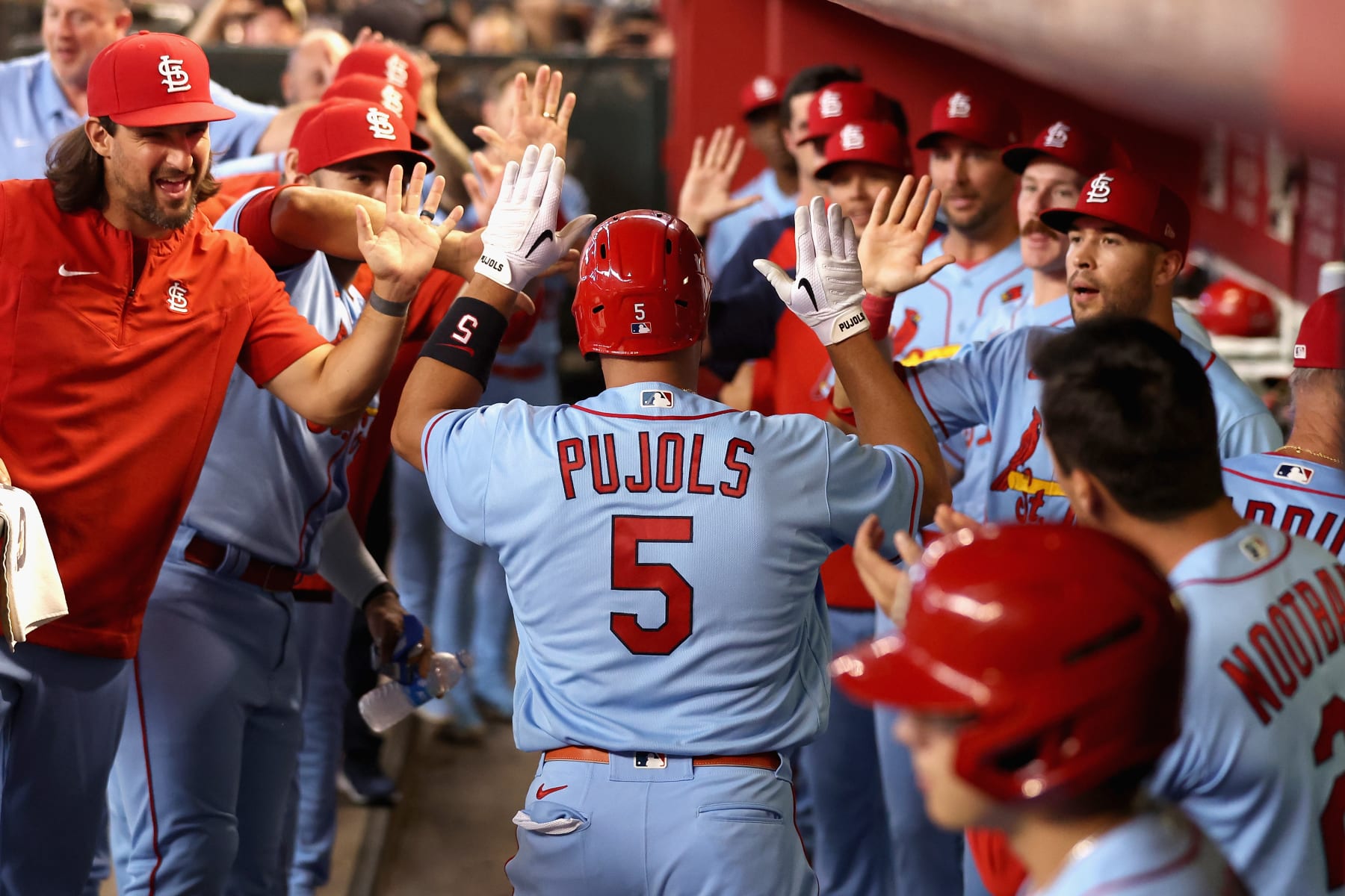 PHOENIX, ARIZONA - AUGUST 20: Albert Pujols #5 of the St. Louis Cardinals high five teammates in the dugout after hitting a solo home run against the Arizona Diamondbacks during the second inning of the MLB game at Chase Field on August 20, 2022 in Phoenix, Arizona. (Photo by Christian Petersen/Getty Images)