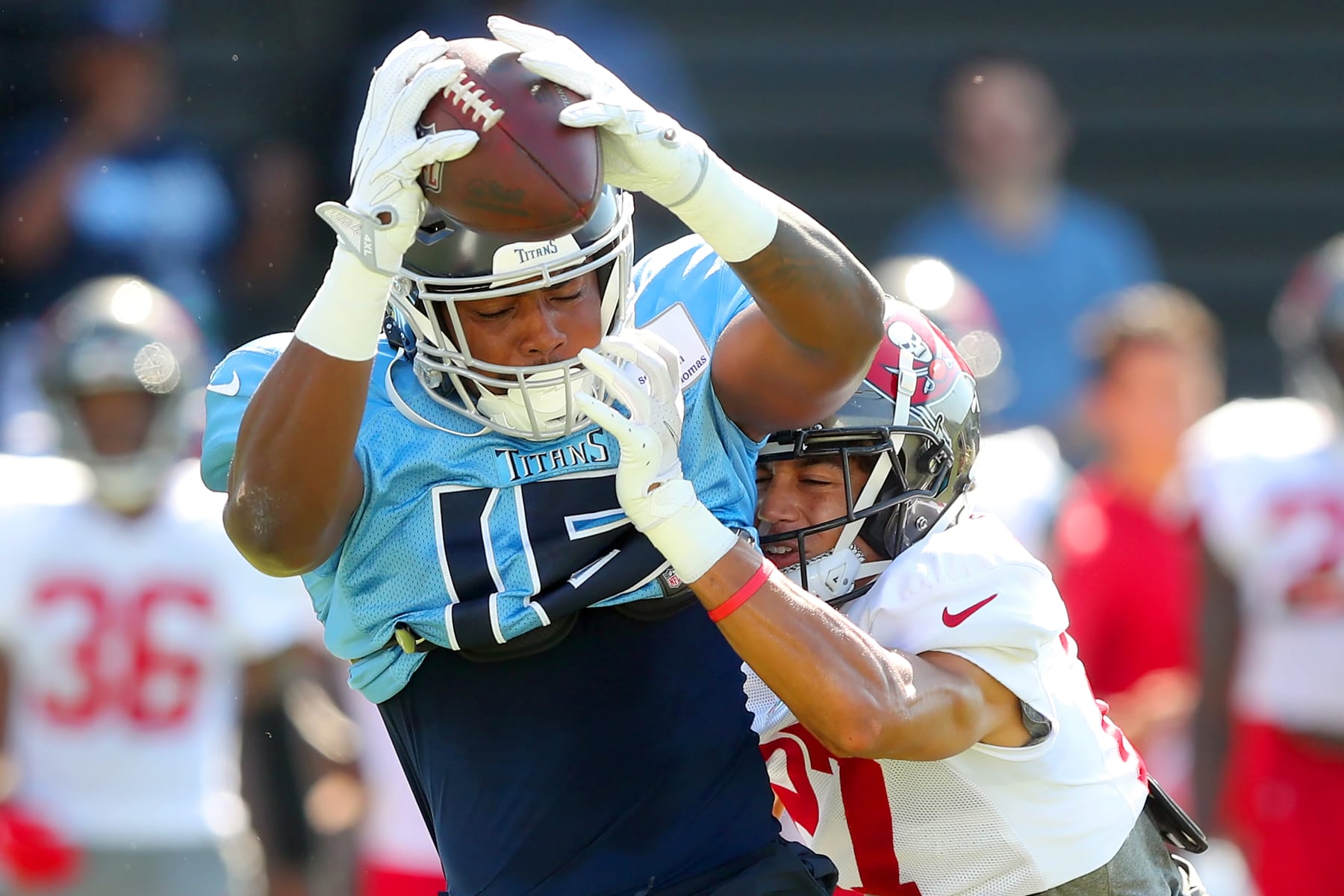 NASHVILLE, TN - AUGUST 18: Tennessee Titans wide receiver Treylon Burks (16) catches a pass as Tampa Bay Buccaneers defensive back Zyon McCollum (27) defends during the Tampa Bay Buccaneers-Tennessee Titans Joint-Practice on August 18, 2022 at Saint Thomas Sports Park in Nashville, TN. (Photo by Cliff Welch/Icon Sportswire via Getty Images)