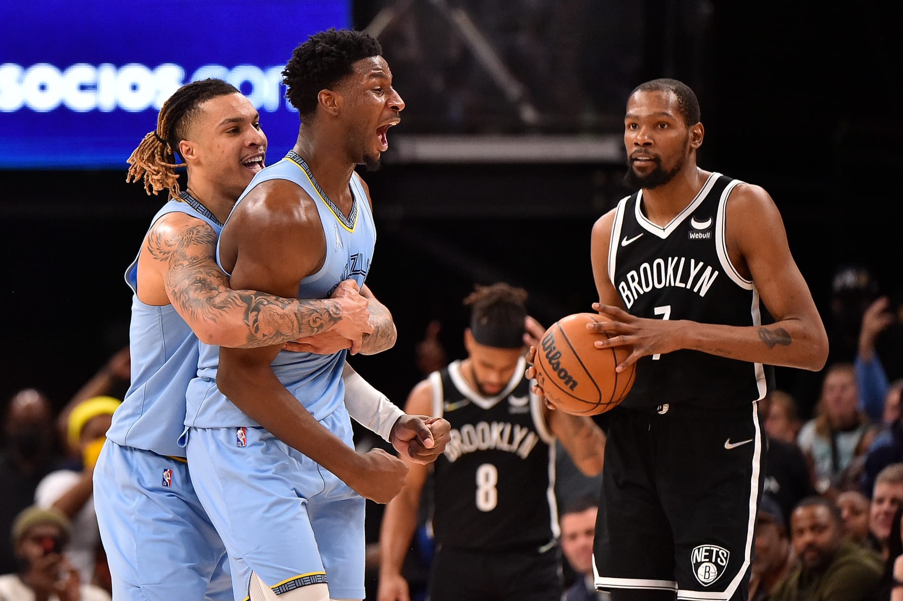 MEMPHIS, TENNESSEE - MARCH 23: Brandon Clarke #15 of the Memphis Grizzlies and Jaren Jackson Jr. #13 of the Memphis Grizzlies celebrate as  Kevin Durant #7 of the Brooklyn Nets looks on during the second half at FedExForum on March 23, 2022 in Memphis, Tennessee. NOTE TO USER: User expressly acknowledges and agrees that , by downloading and or using this photograph, User is consenting to the terms and conditions of the Getty Images License Agreement. (Photo by Justin Ford/Getty Images)