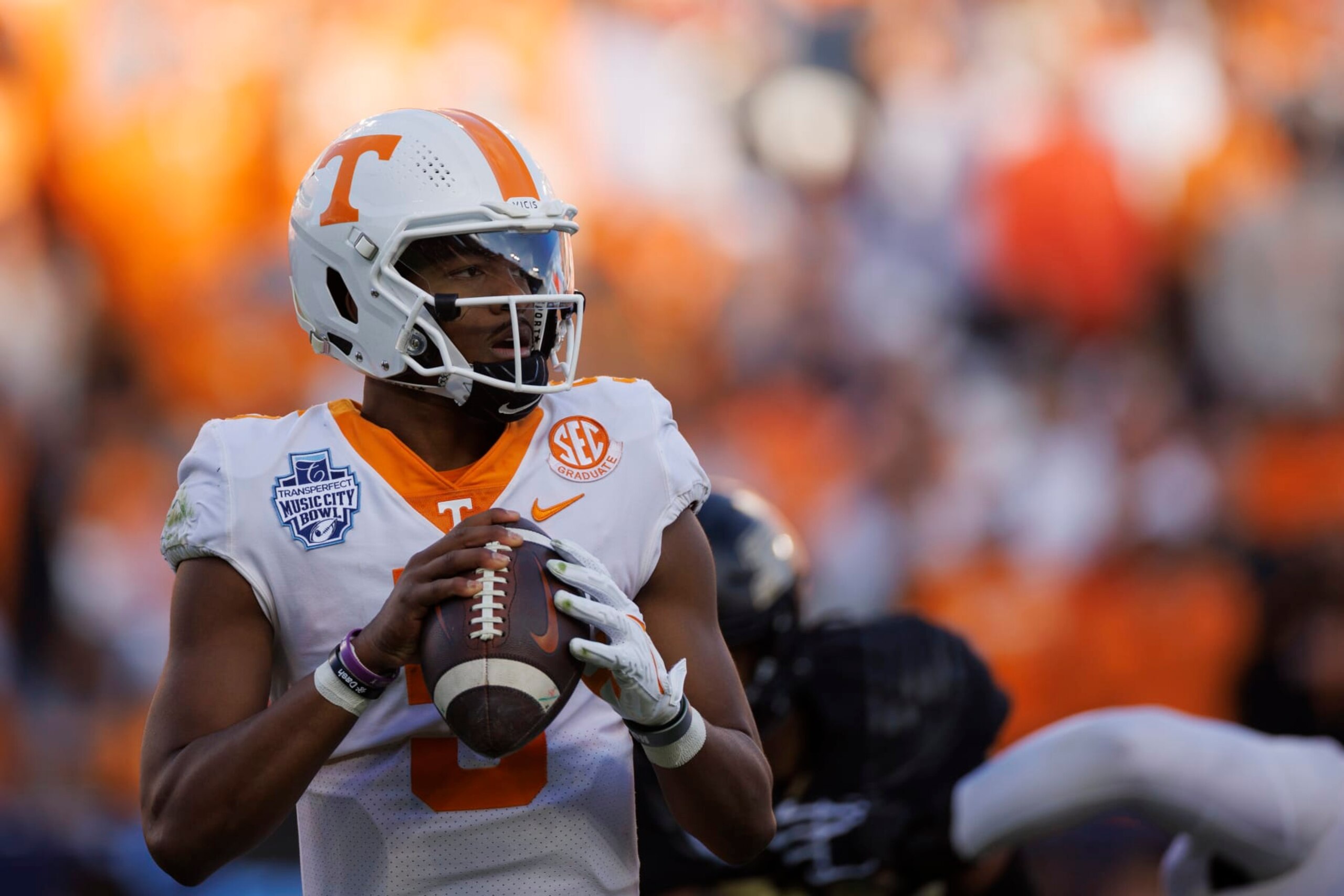 NASHVILLE, TN - DECEMBER 30: Hendon Hooker #5 of the Tennessee Volunteers drops back to pass against the Purdue Boilermakers during the first half of the TransPerfect Music City Bowl at Nissan Stadium on December 30, 2021 in Nashville, Tennessee. (Photo by Brett Carlsen/Getty Images) NASHVILLE, TN - DECEMBER 30: Hendon Hooker #5 of the Tennessee Volunteers drops back to pass against the Purdue Boilermakers during the first half of the TransPerfect Music City Bowl at Nissan Stadium on December 30, 2021 in Nashville, Tennessee. (Photo by Brett Carlsen/Getty Images)