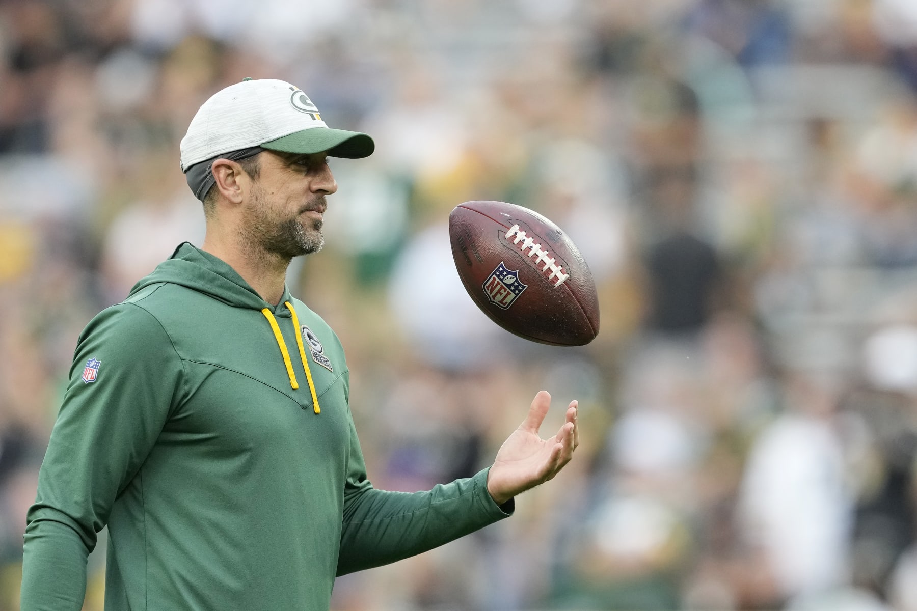 GREEN BAY, WISCONSIN - AUGUST 19: Aaron Rodgers #12 of the Green Bay Packers looks on before a preseason game against the New Orleans Saints at Lambeau Field on August 19, 2022 in Green Bay, Wisconsin. (Photo by Patrick McDermott/Getty Images)