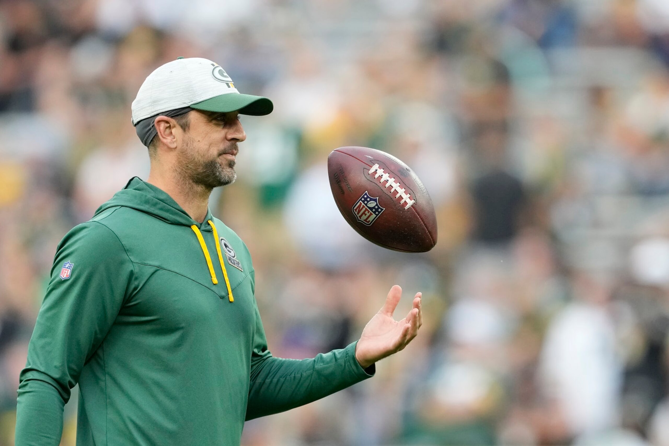 GREEN BAY, WISCONSIN - AUGUST 19: Aaron Rodgers #12 of the Green Bay Packers looks on before a preseason game against the New Orleans Saints at Lambeau Field on August 19, 2022 in Green Bay, Wisconsin. (Photo by Patrick McDermott/Getty Images)