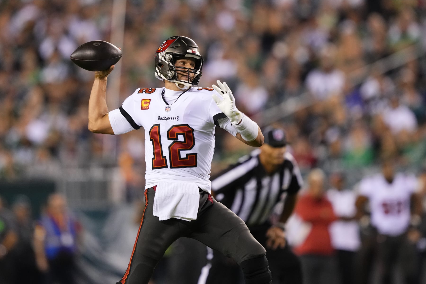 FILE - Tampa Bay Buccaneers' Tom Brady plays during an NFL football game in Philadelphia, Pa., on Thursday, Oct. 14, 2021. Brady cited “unfinished business” as one of the reasons for ending a brief retirement, and the Tampa Bay Buccaneers remain committed to surrounding the seven-time Super Bowl champion with everything he needs to win an eighth ring. (AP Photo/Matt Slocum, File)