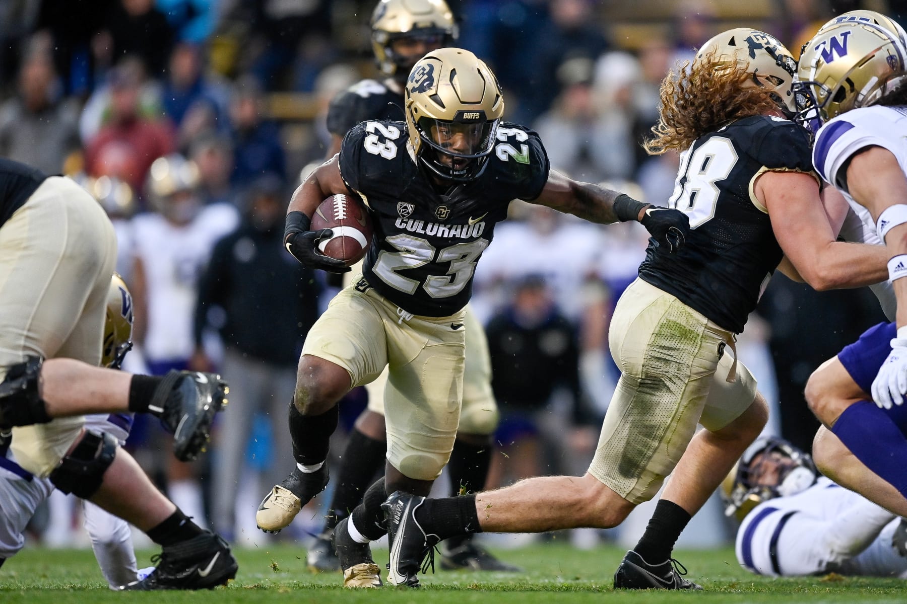 BOULDER, CO - NOVEMBER 20:  Running back Jarek Broussard #23 of the Colorado Buffaloes carries the ball against the Washington Huskies at Folsom Field on November 20, 2021 in Boulder, Colorado. (Photo by Dustin Bradford/Getty Images)