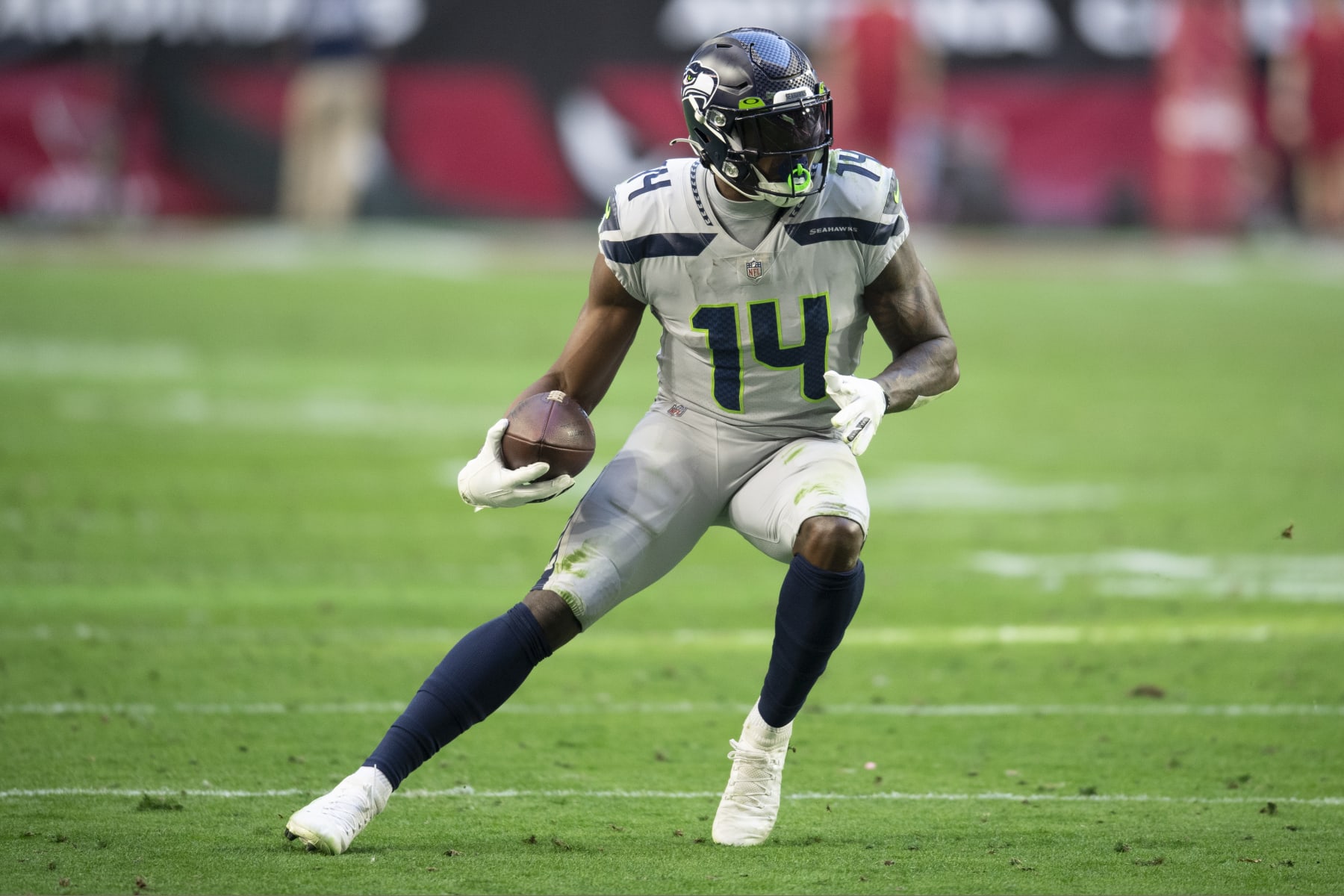 Seattle Seahawks wide receiver DK Metcalf (14) runs the ball against the Arizona Cardinals during an NFL Professional Football Game Sunday, Jan. 9, 2022, in Phoenix. (AP Photo/John McCoy)