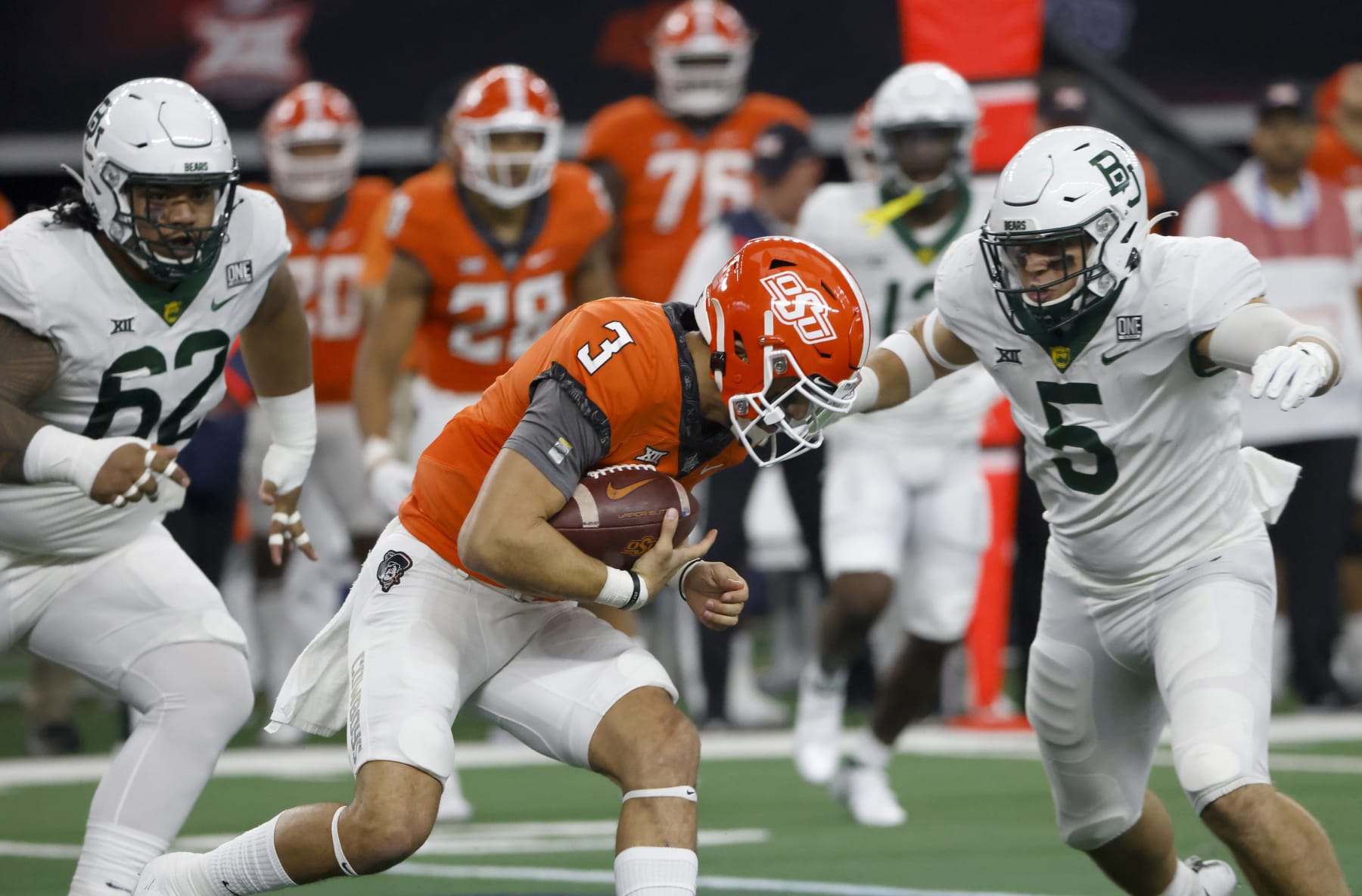ARLINGTON, TX - DECEMBER 4: Spencer Sanders #3 of the Oklahoma State Cowboys is met by Dillon Doyle #5 and Siaki Ika #62 of the Baylor Bears in the first half of the Big 12 Football Championship at AT&T Stadium on December 4, 2021 in Arlington, Texas. (Photo by Ron Jenkins/Getty Images)