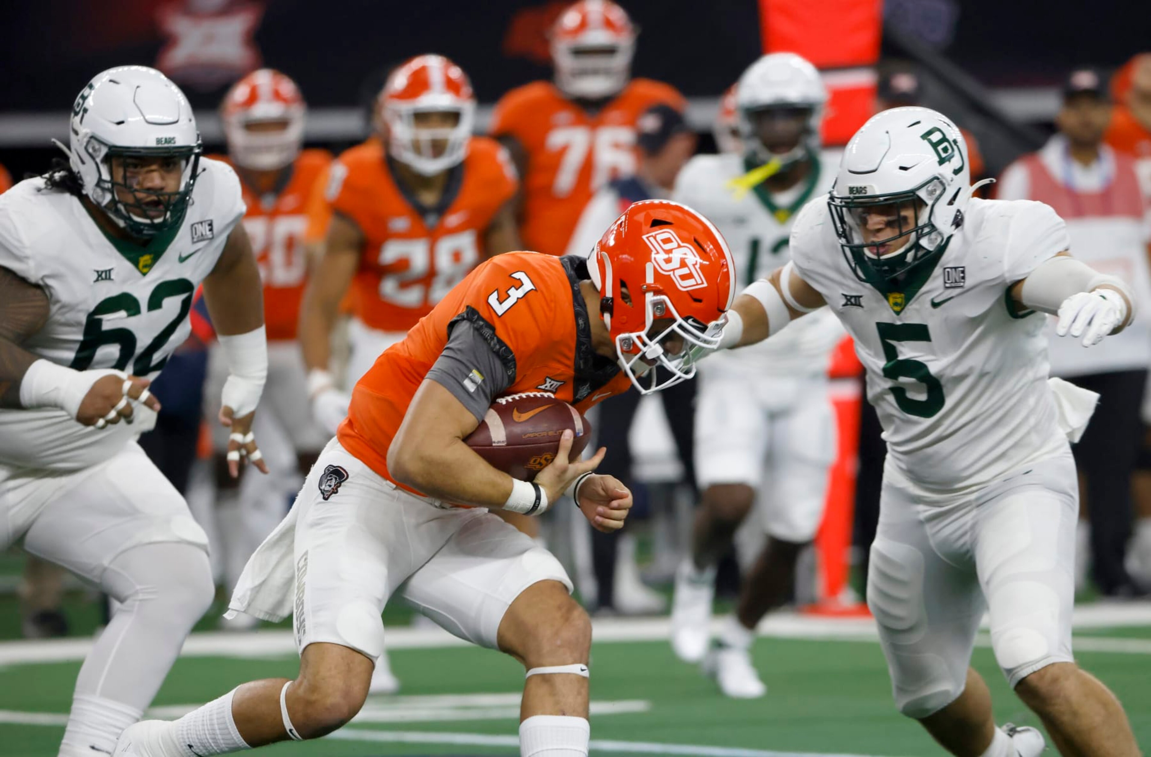 ARLINGTON, TX - DECEMBER 4: Spencer Sanders #3 of the Oklahoma State Cowboys is met by Dillon Doyle #5 and Siaki Ika #62 of the Baylor Bears in the first half of the Big 12 Football Championship at AT&T Stadium on December 4, 2021 in Arlington, Texas. (Photo by Ron Jenkins/Getty Images)
