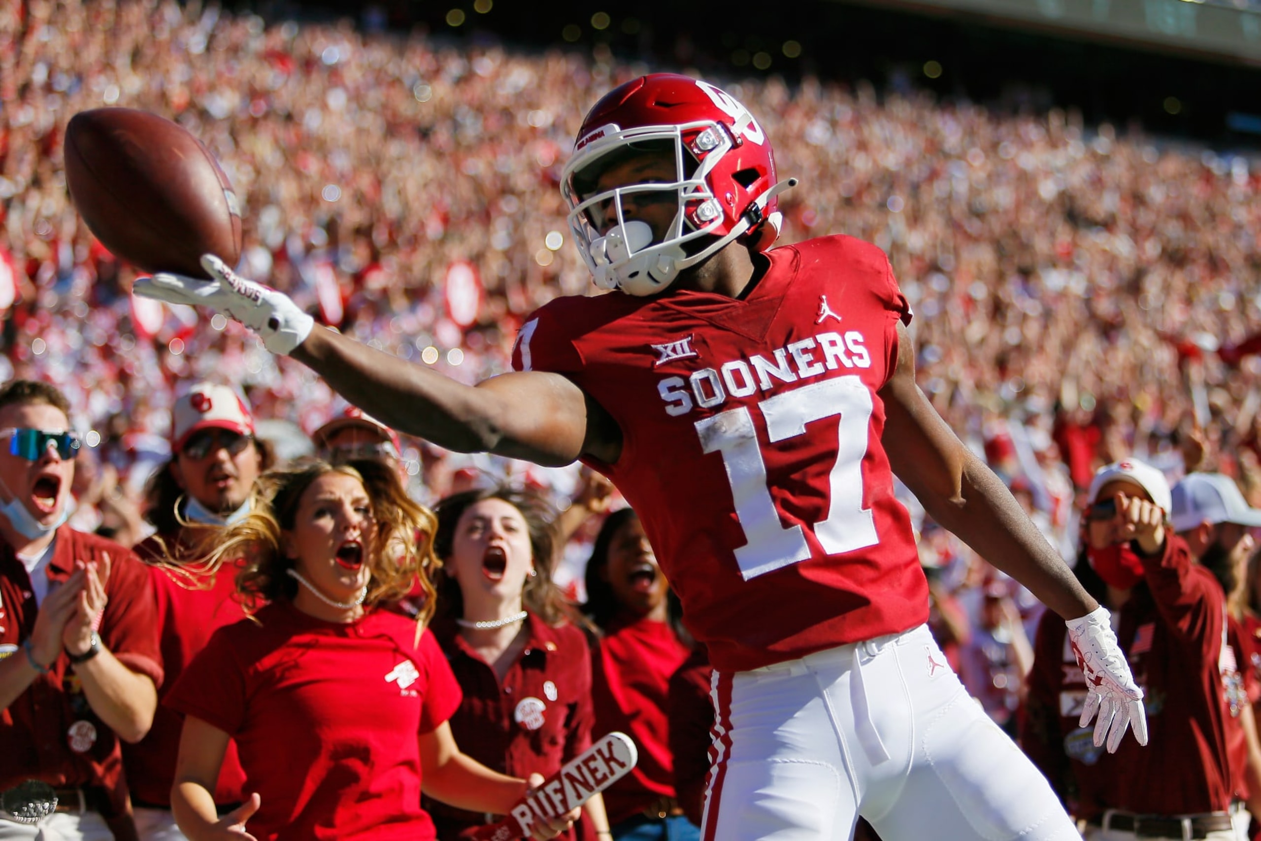 NORMAN, OK - OCTOBER 30: Wide receiver Marvin Mims #17 of the Oklahoma Sooners rolls the ball off his fingertips after scoring on a 67-yard catch and run against the Texas Tech Red Raiders in the first quarter at Gaylord Family Oklahoma Memorial Stadium on October 30, 2021 in Norman, Oklahoma. (Photo by Brian Bahr/Getty Images) NORMAN, OK - OCTOBER 30: Wide receiver Marvin Mims #17 of the Oklahoma Sooners rolls the ball off his fingertips after scoring on a 67-yard catch and run against the Texas Tech Red Raiders in the first quarter at Gaylord Family Oklahoma Memorial Stadium on October 30, 2021 in Norman, Oklahoma. (Photo by Brian Bahr/Getty Images)